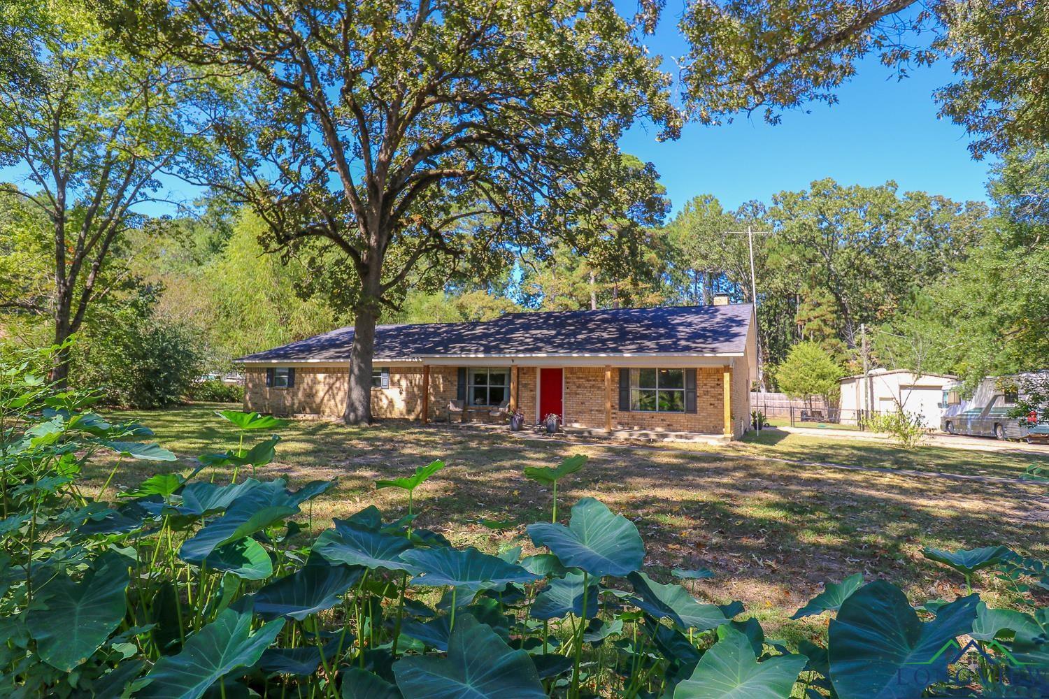 Image 0: Ranch-style house with brick siding and a porch, Front Of Structure