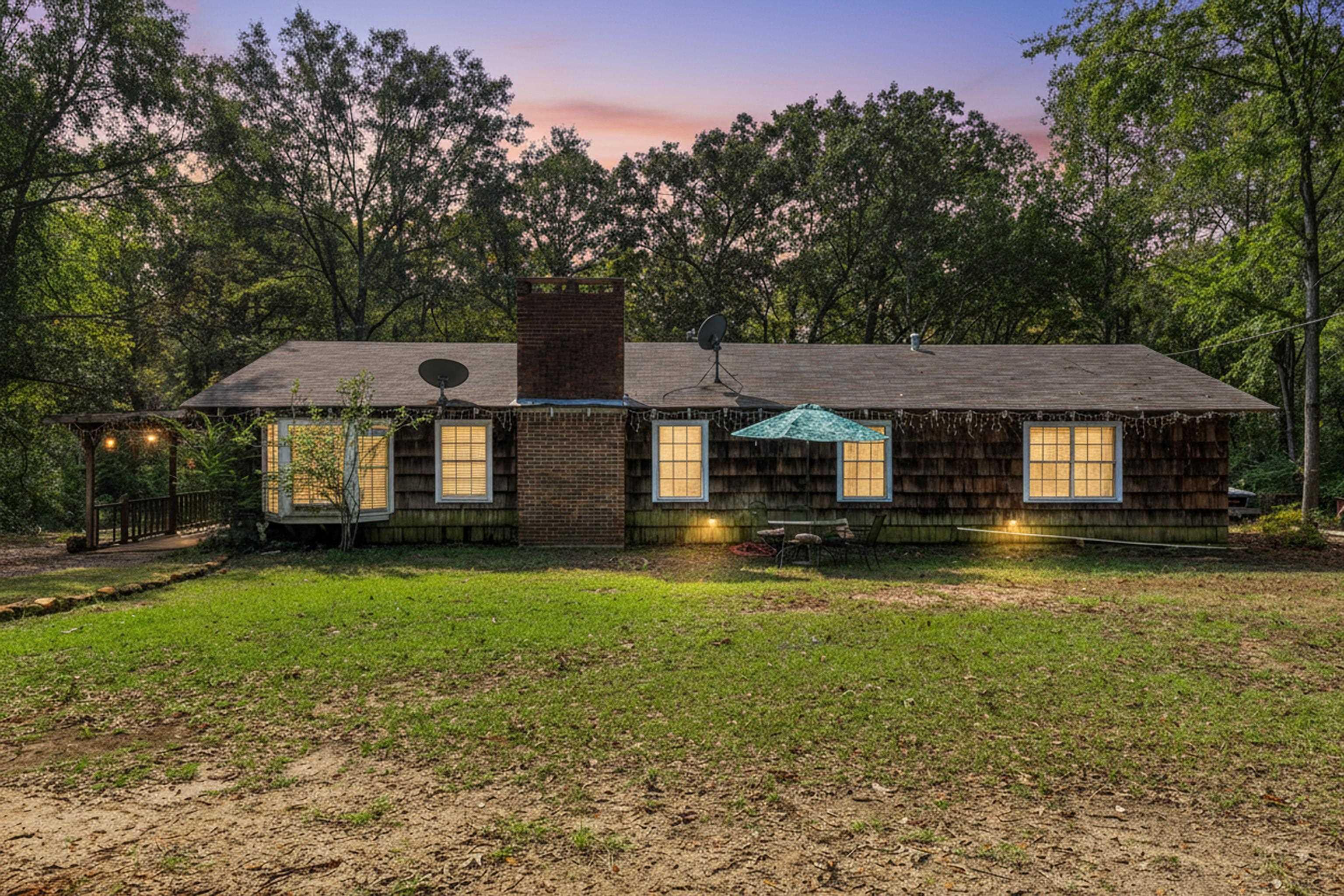 Image 0: Ranch-style home featuring a yard and a chimney, Front Of Structure