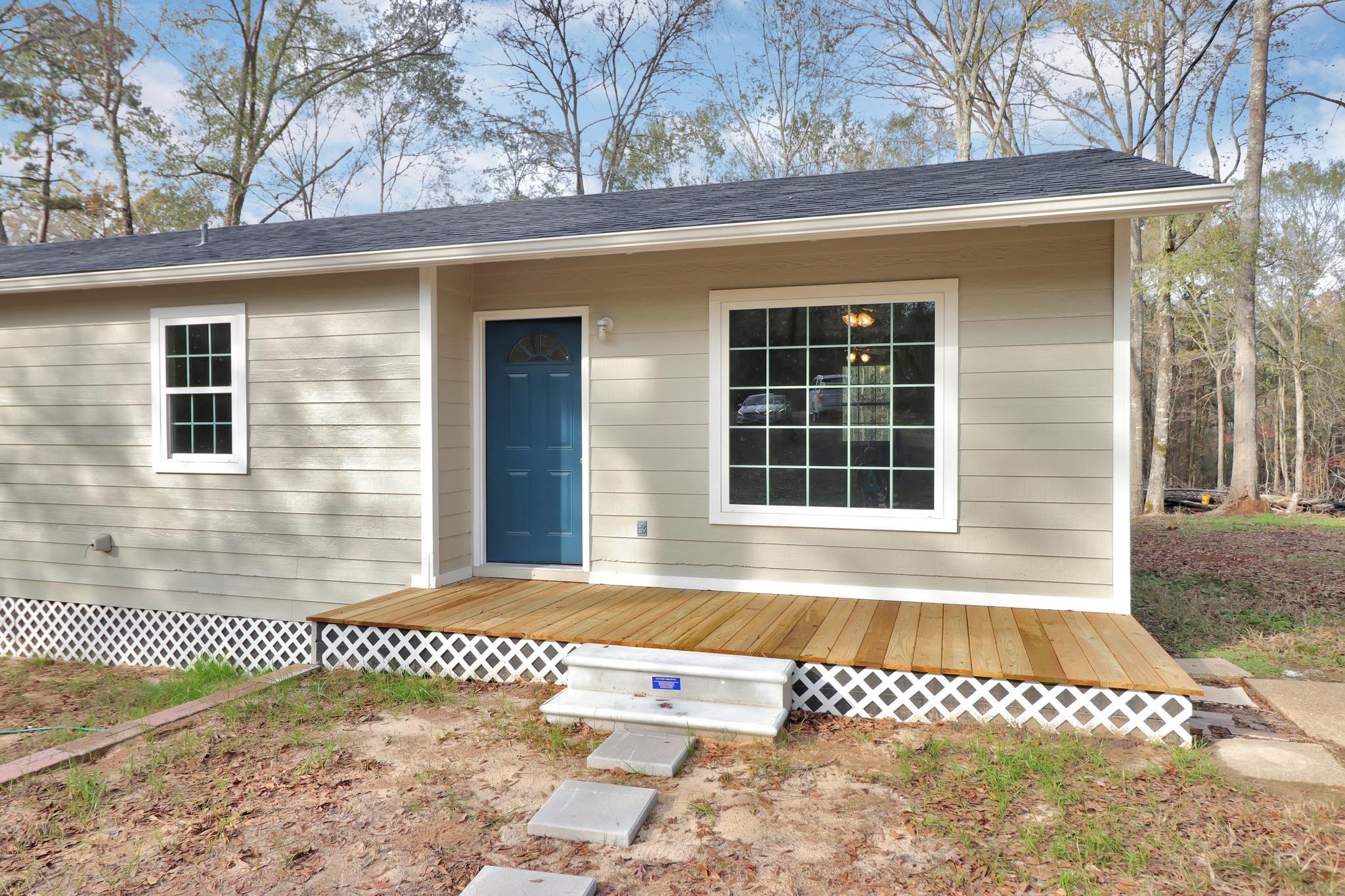 Image 2: View of exterior entry with a deck and roof with shingles, Entry