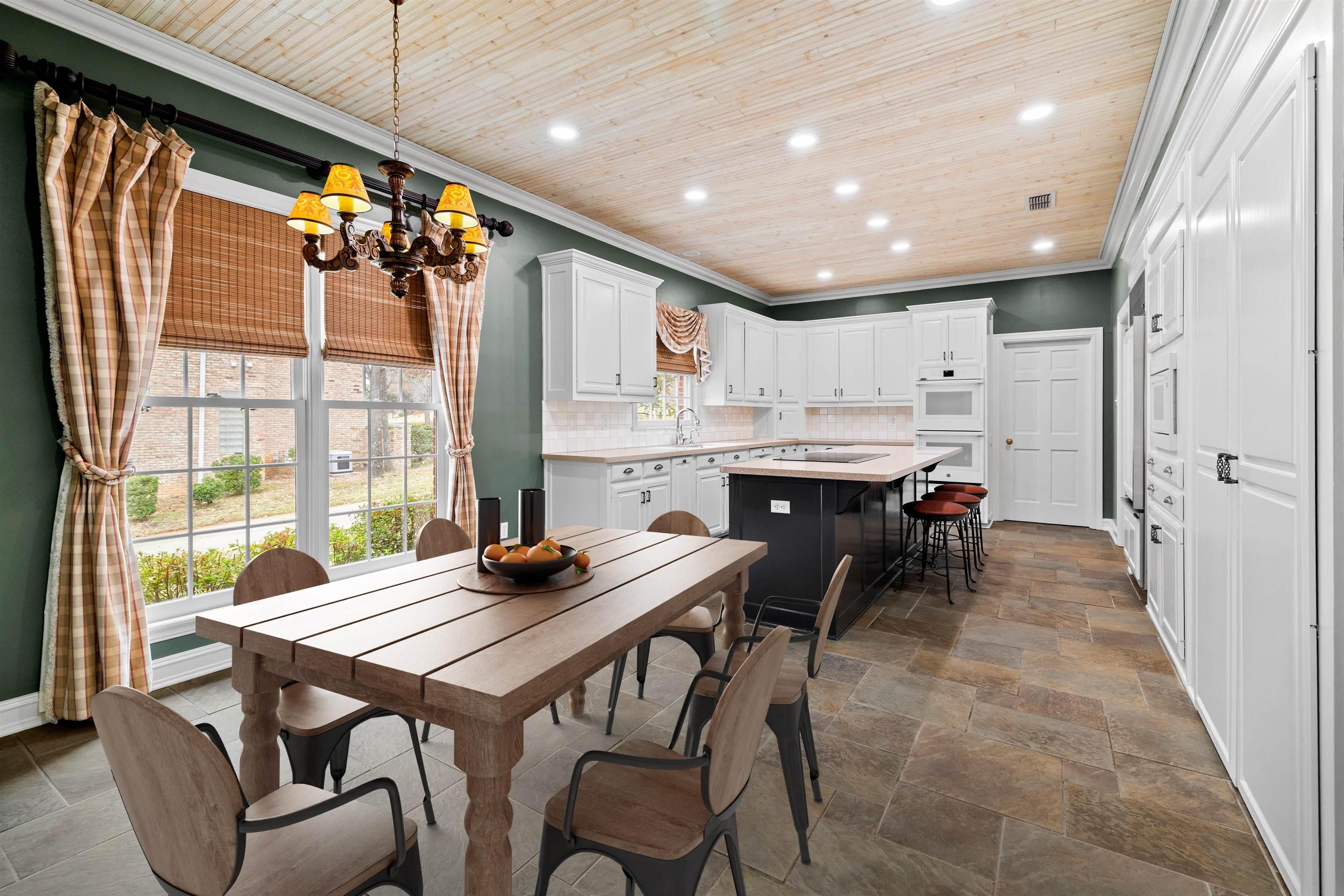 Image 2: Dining room with wood ceiling, recessed lighting, crown molding, a chandelier, and stone tile flooring, Dining Area