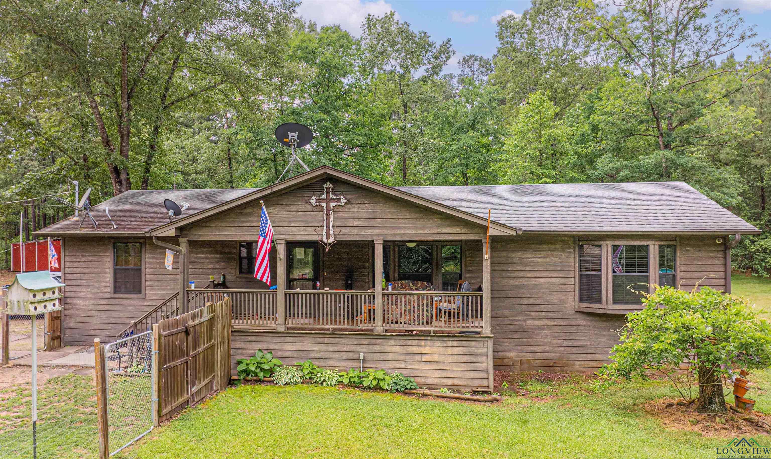 Image 2: View of front facade with roof with shingles, covered porch, and a front lawn, Front Of Structure