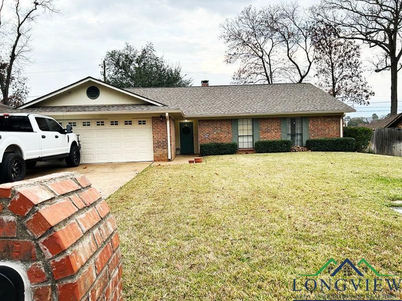 Image 0: Single story home featuring an attached garage, brick siding, concrete driveway, and a shingled roof, Front Of Structure