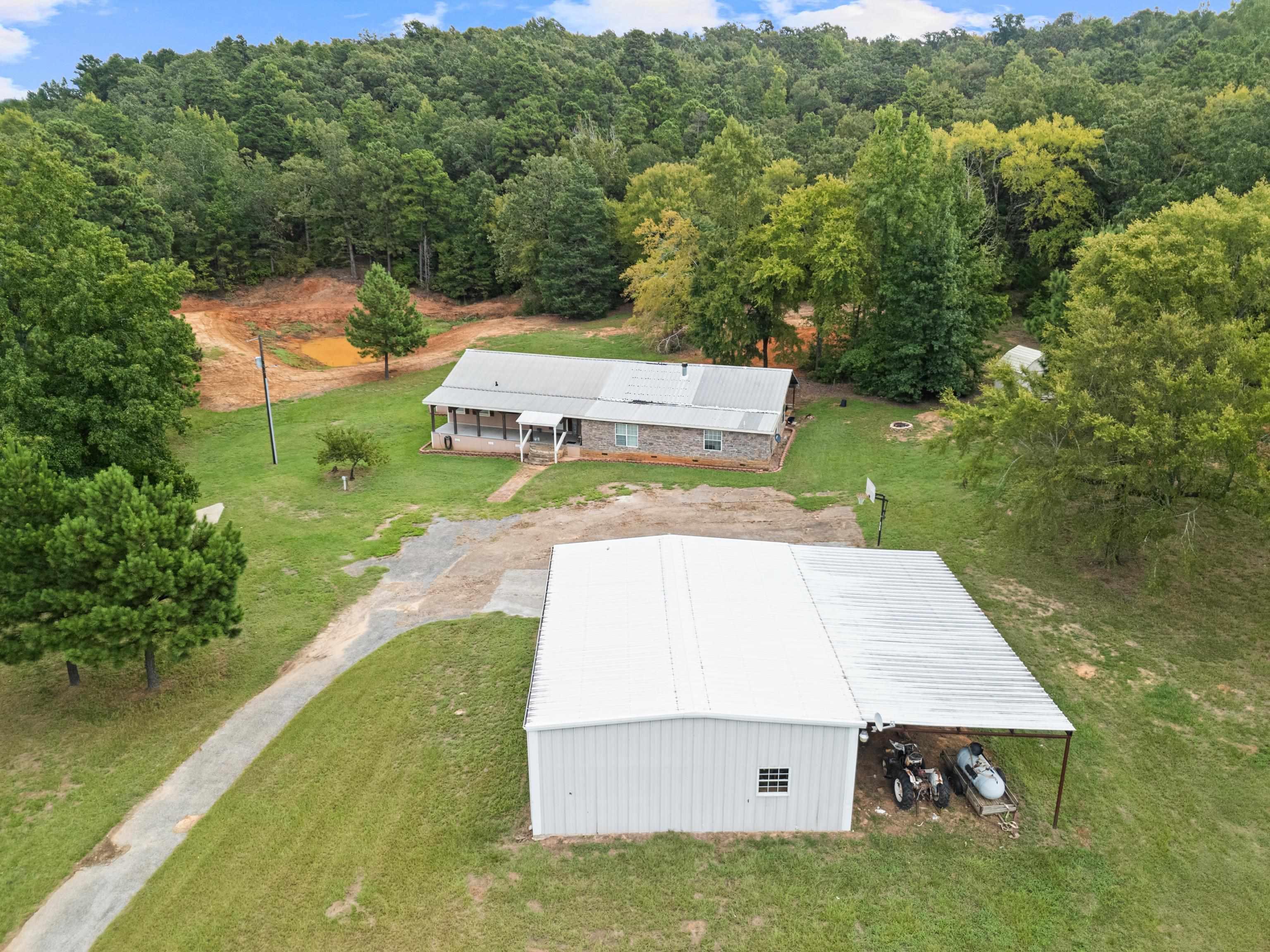 Image 2: View from above of property with a heavily wooded area, Aerial View