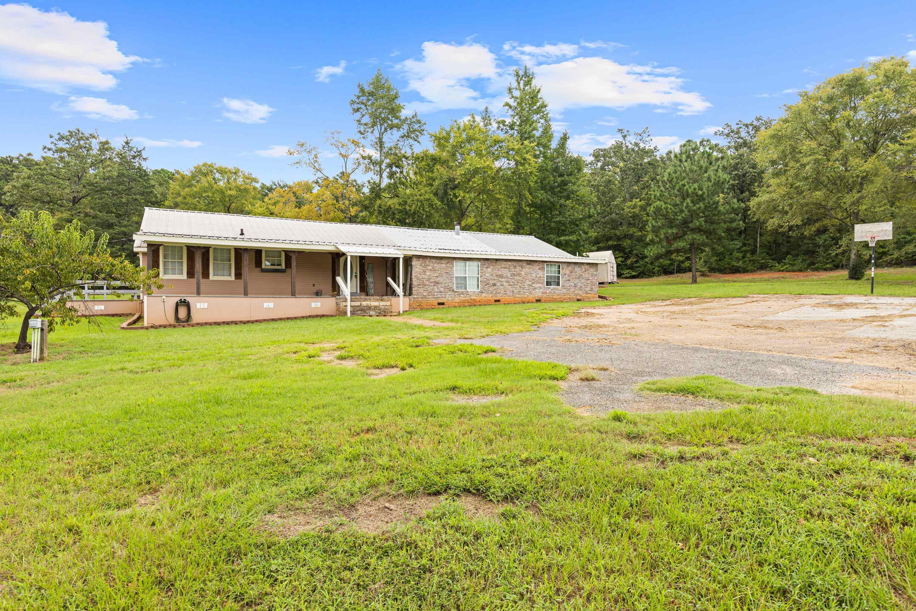 Image 3: View of front of house featuring a porch, a front yard, a metal roof, and crawl space, Front Of Structure