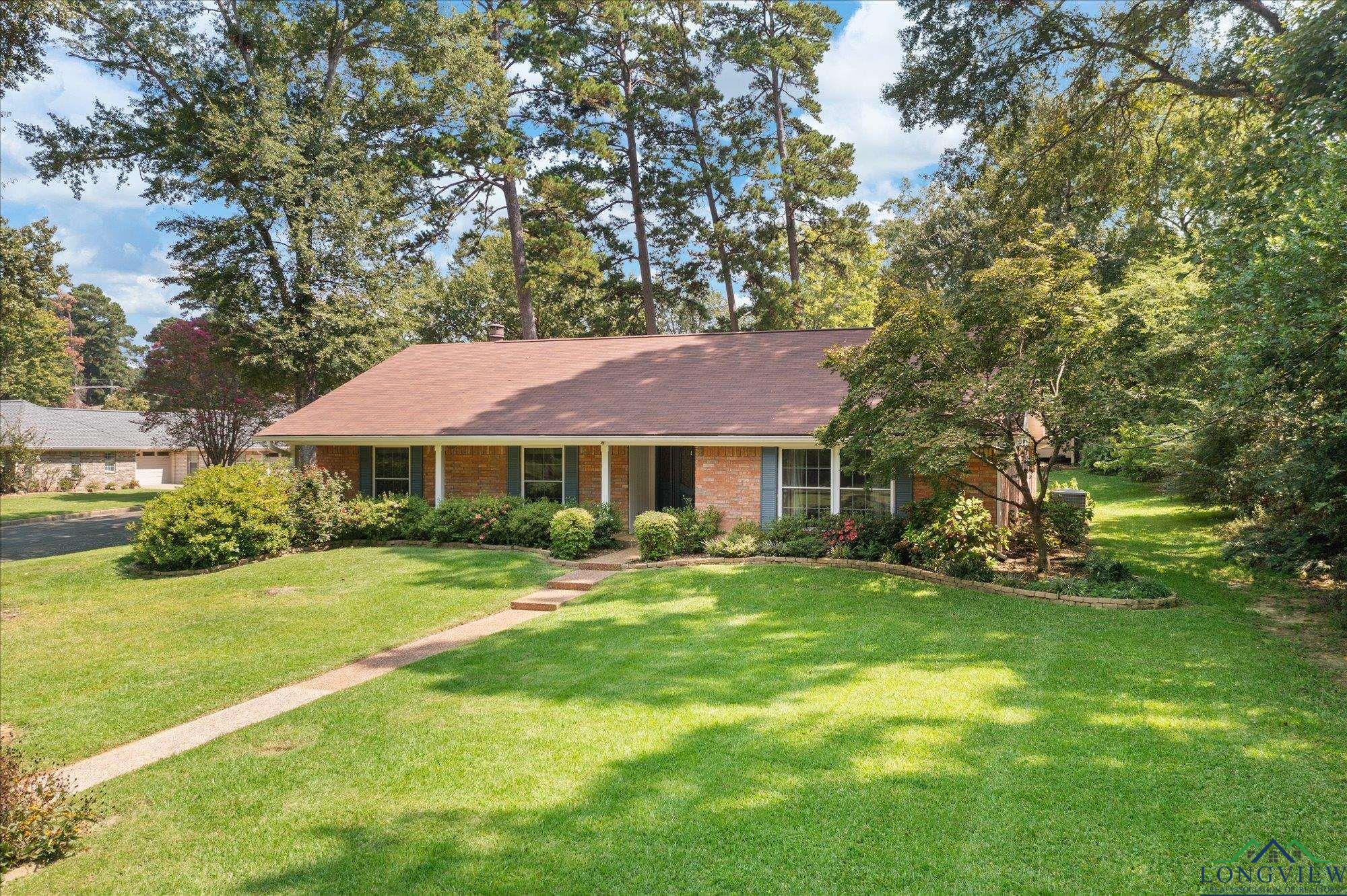 Image 0: Ranch-style home with brick siding, a front yard, and covered porch, Front Of Structure