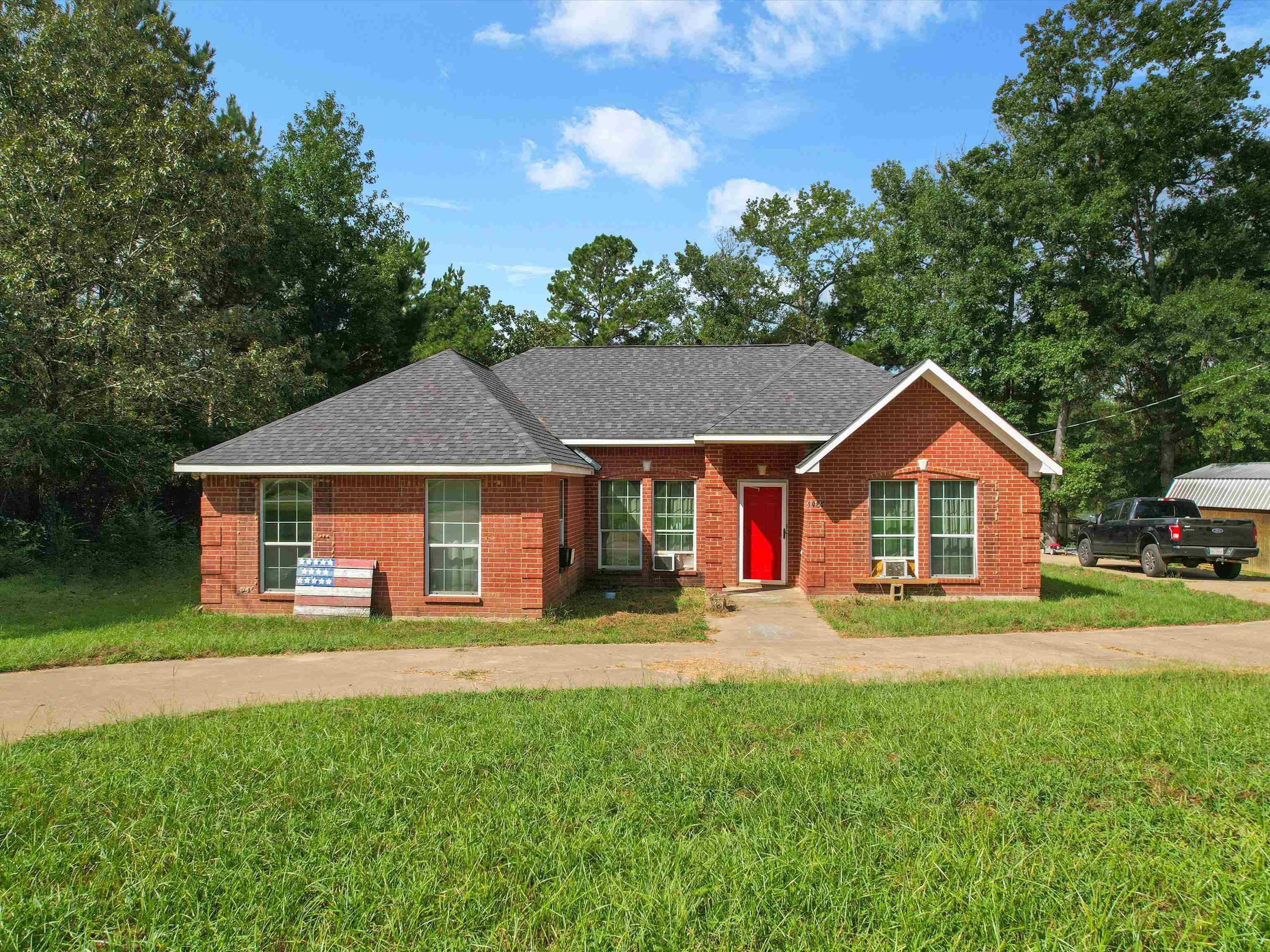 Image 0: Ranch-style home with a front lawn, brick siding, and a shingled roof, Front Of Structure