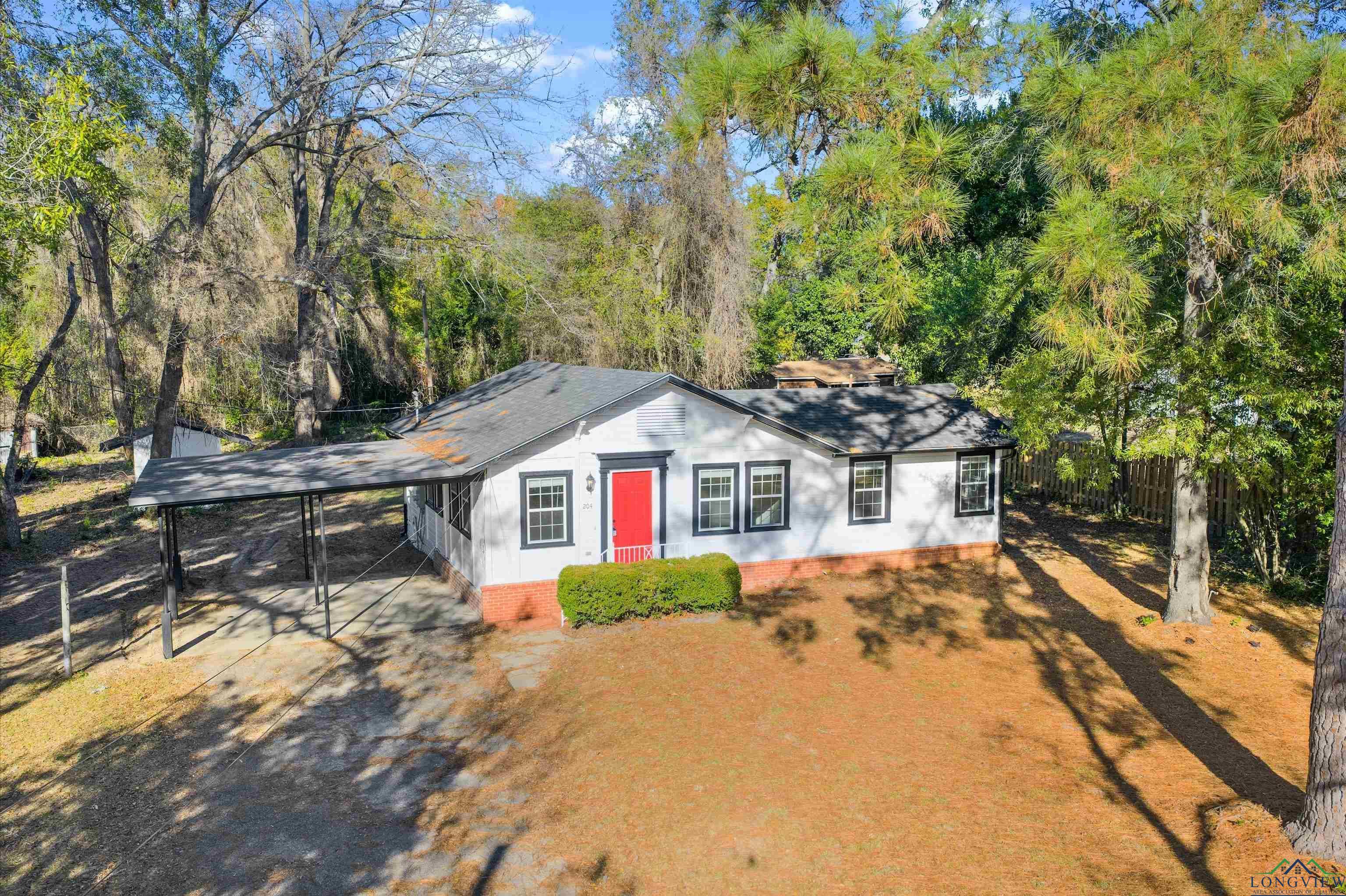 Image 1: View of front of home with an attached carport, roof with shingles, and driveway, Front Of Structure