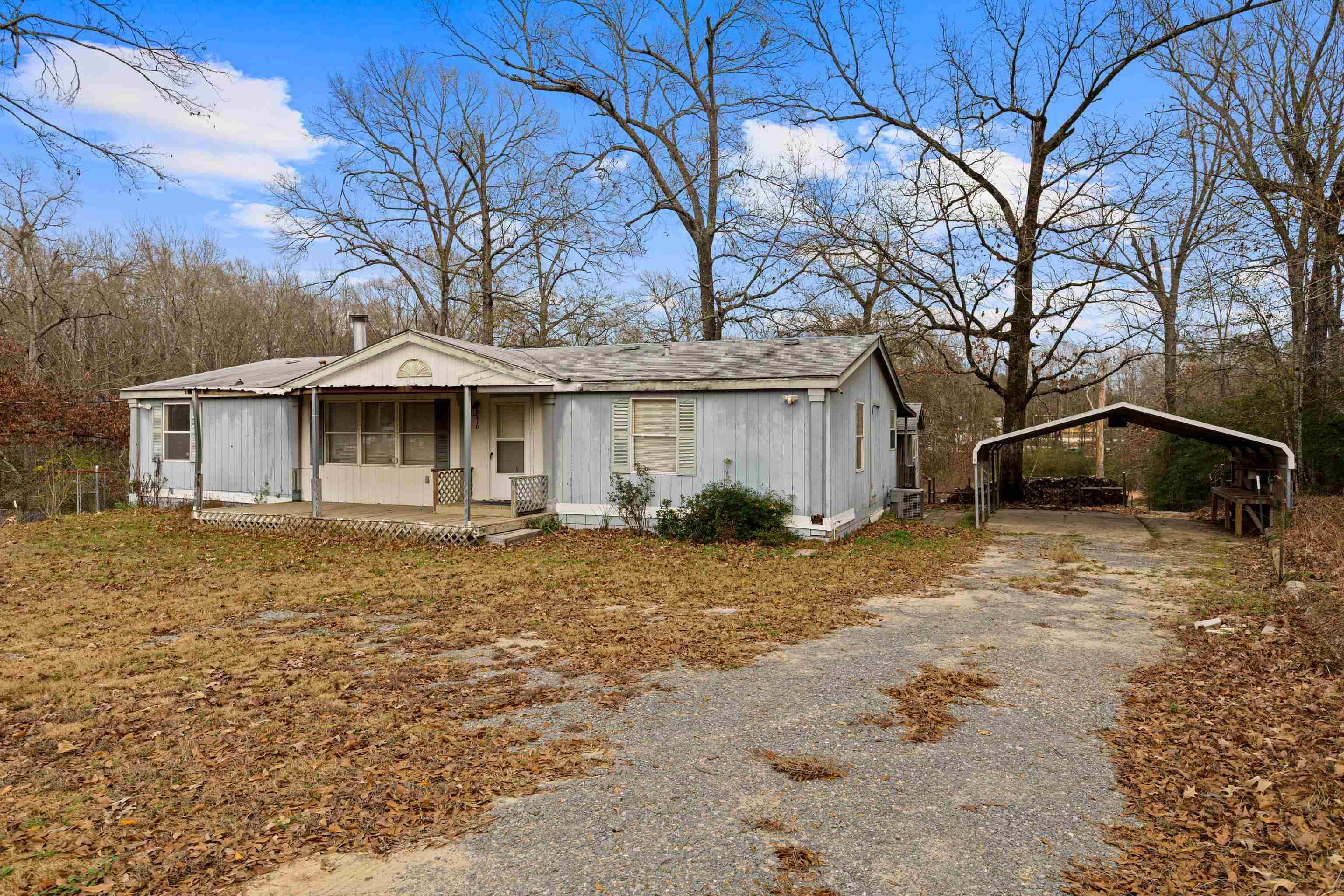 Image 0: Bungalow-style home featuring a carport, covered porch, and driveway, Front Of Structure
