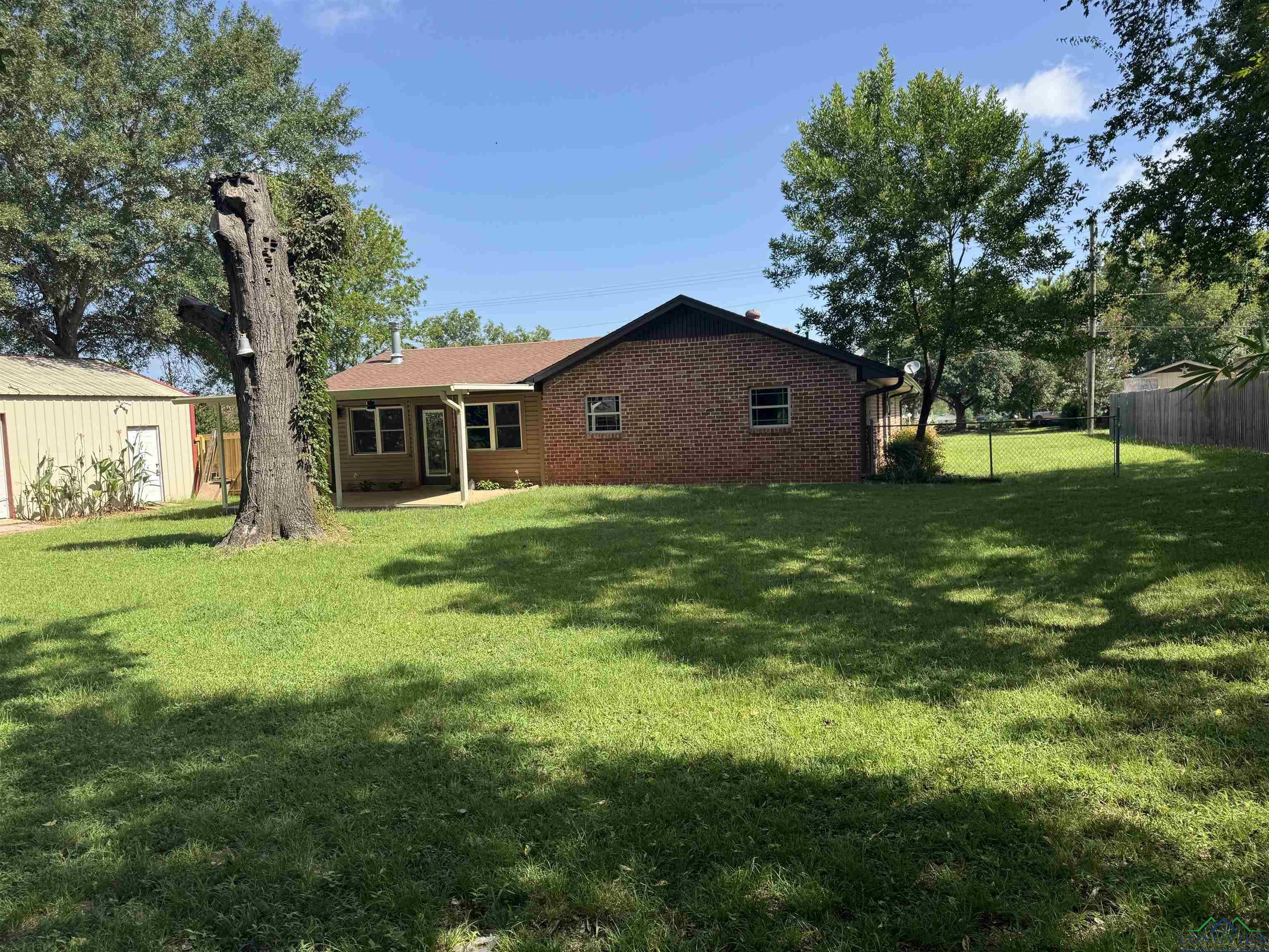 Image 2: Back of house featuring brick siding, Back Of Structure