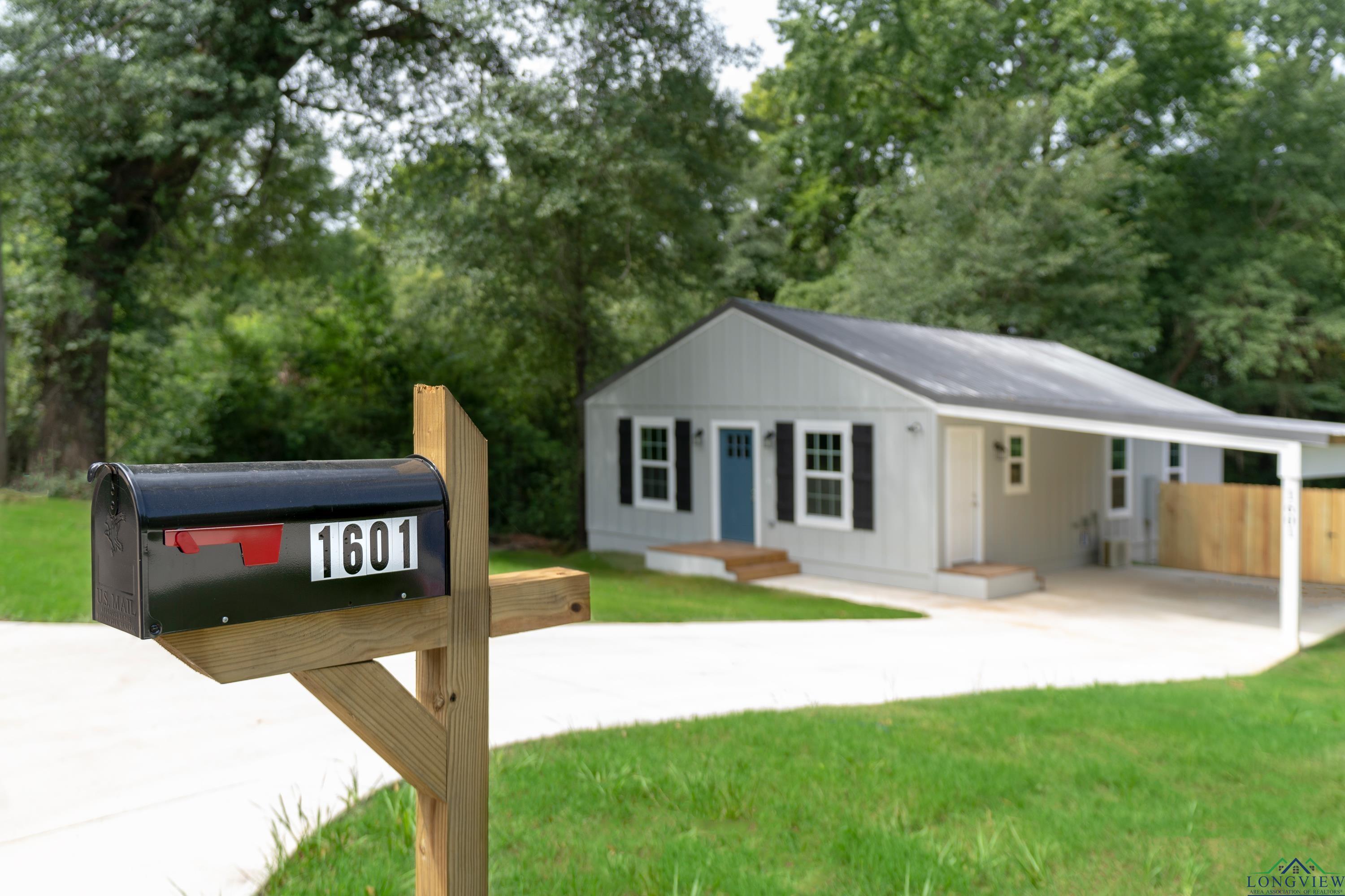 Image 2: View of front facade featuring a front lawn and driveway, Front Of Structure