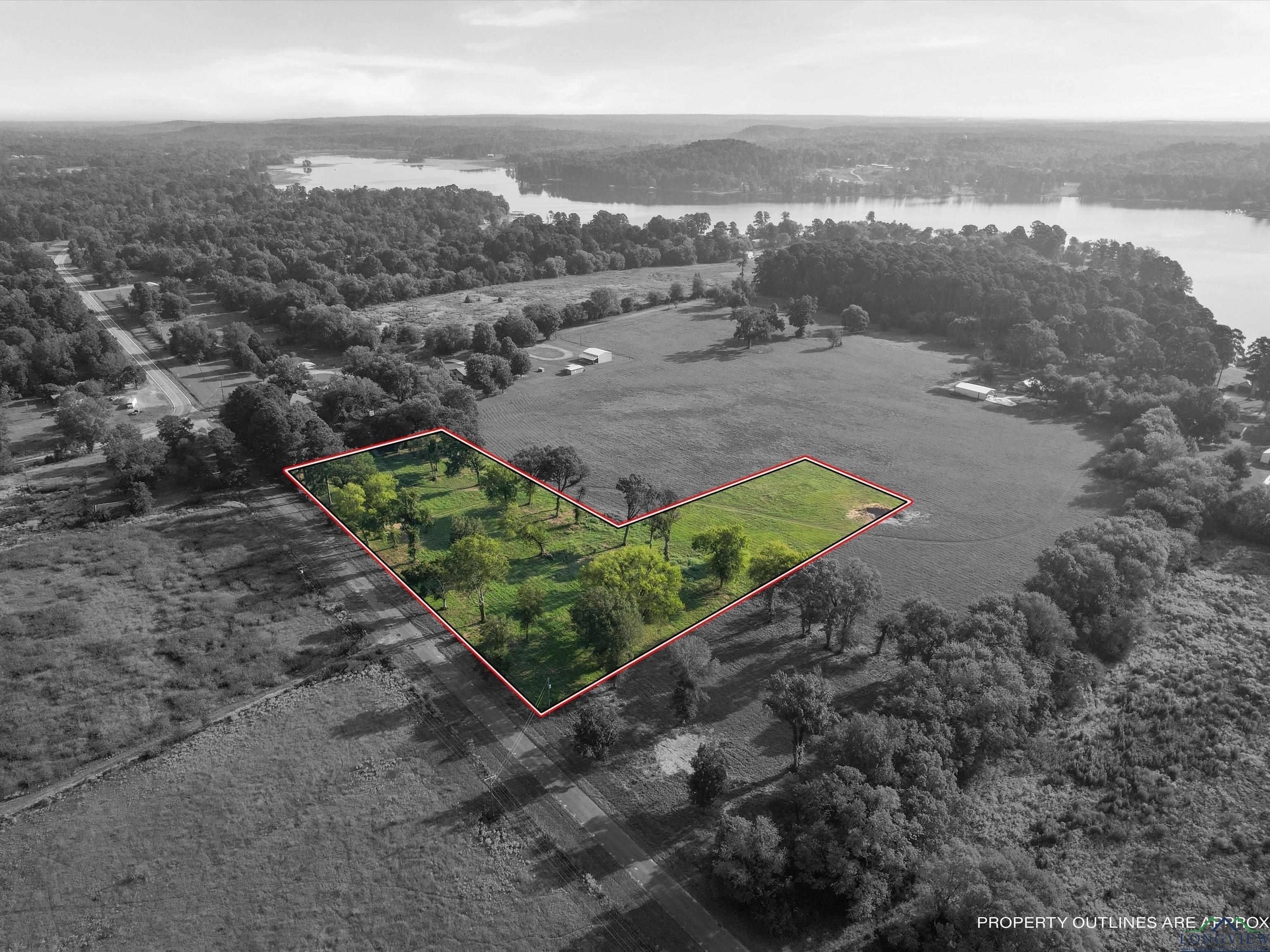 Image 3: Aerial overview of property's location featuring property boundaries highlighted and a large body of water, Aerial View