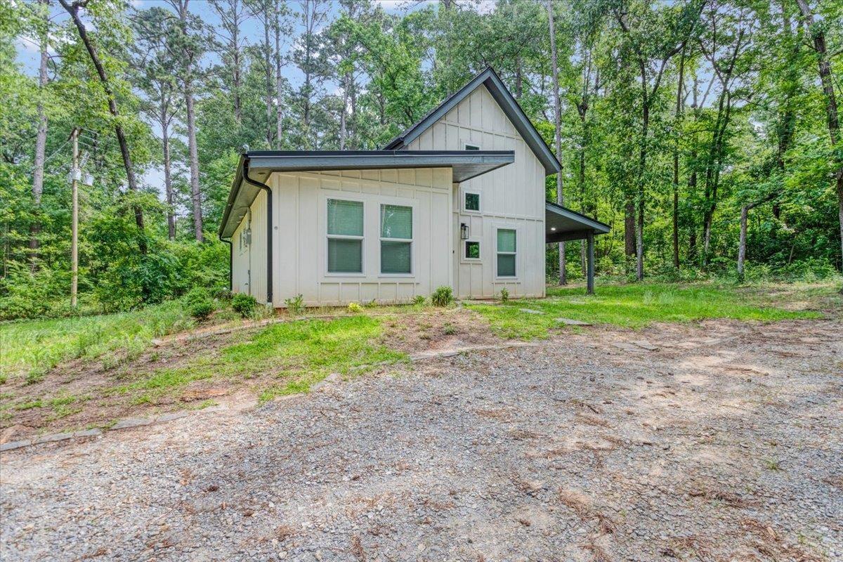 Image 3: Back of house with board and batten siding, Back Of Structure