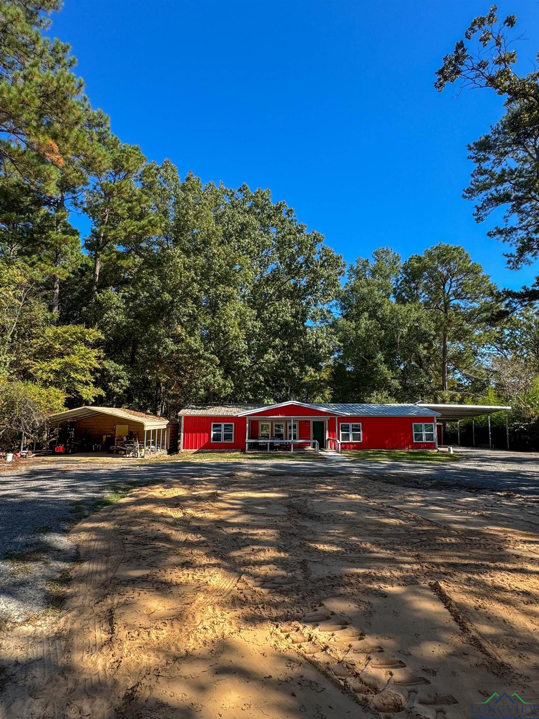 Image 0: View of front of house with driveway, covered porch, and a carport, Front Of Structure
