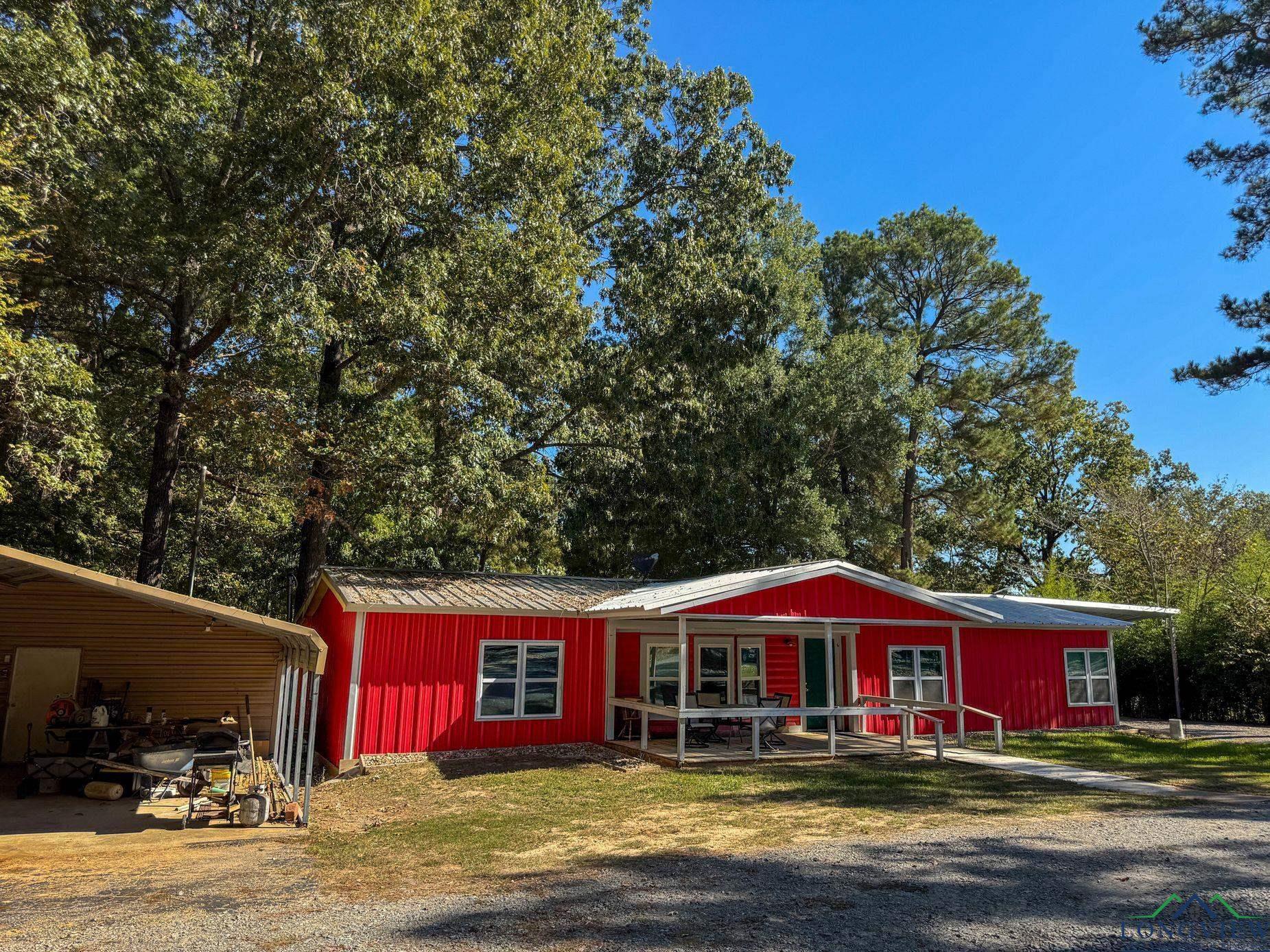 Image 1: Manufactured / mobile home with a carport and a porch, Front Of Structure