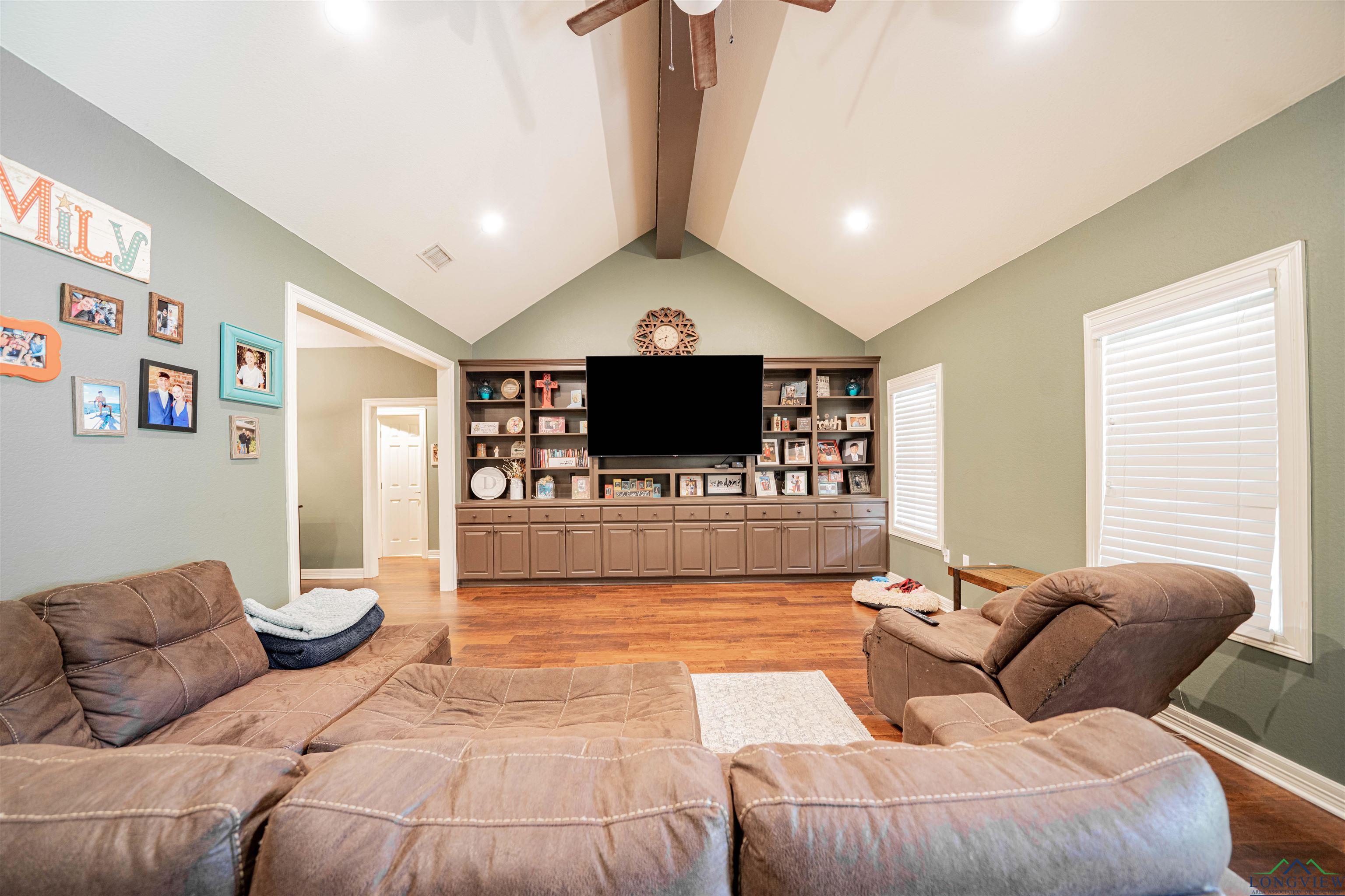Image 1: Living area with light wood-style flooring and a ceiling fan, Living Room