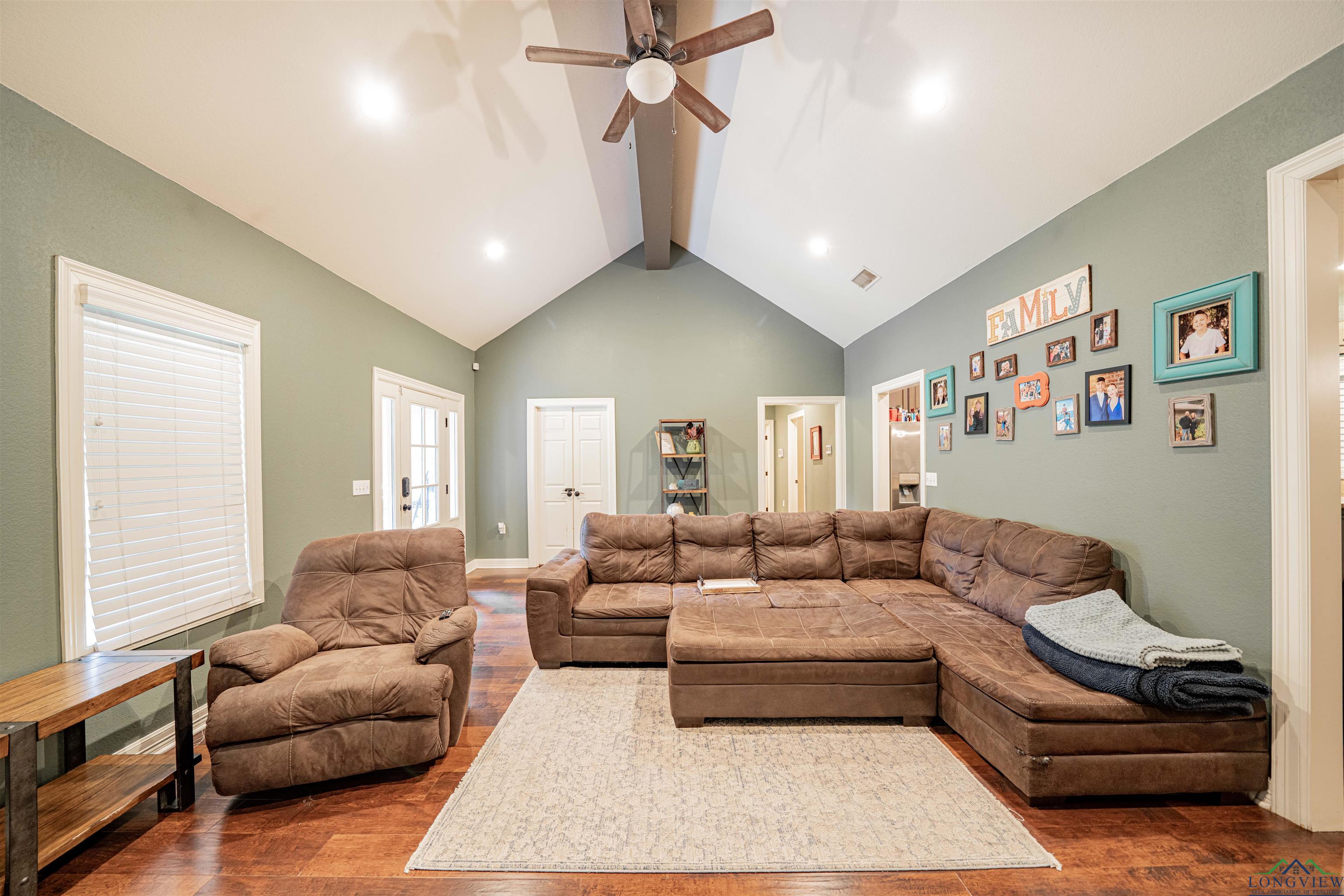 Image 2: Living room featuring dark wood-style floors, ceiling fan, and recessed lighting, Living Room