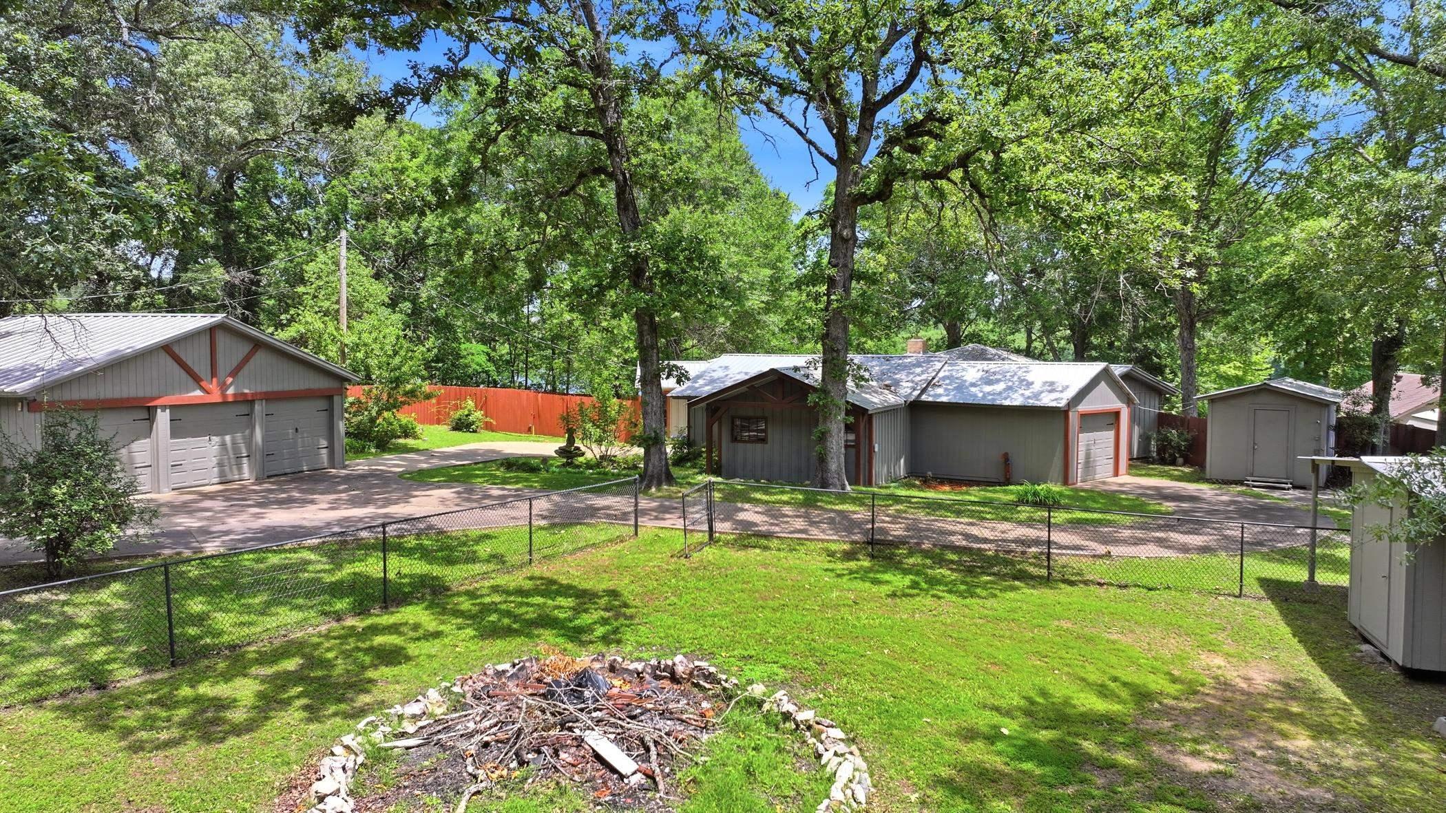 Image 3: View from the front yard of the home and 3 car garage on the left, Yard