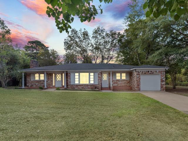 Image 0: Single story home with an attached garage, a chimney, a front lawn, concrete driveway, and brick siding, Front Of Structure