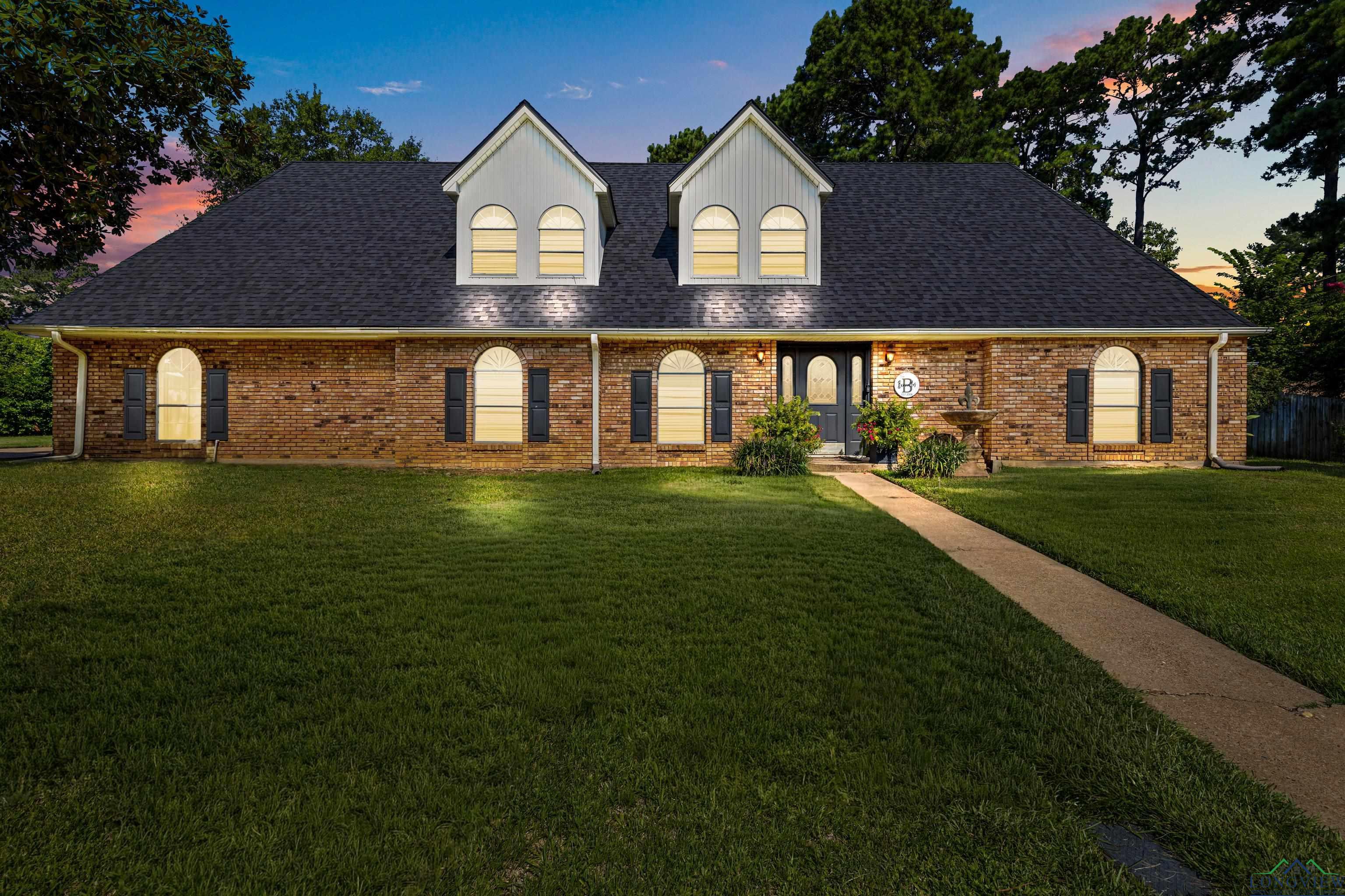 Image 0: Cape cod home with a lawn, brick siding, and roof with shingles, Front Of Structure