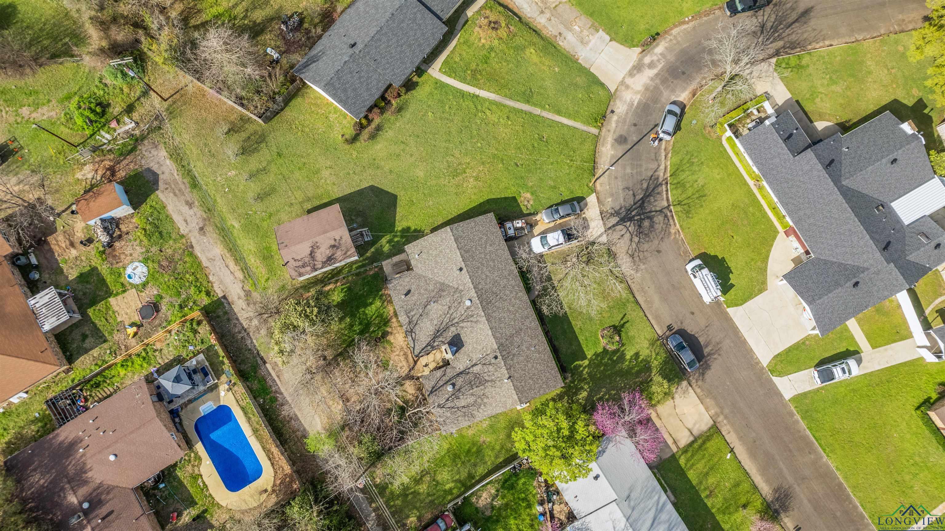 Image 2: Aerial view of residential area featuring a pool, Aerial View