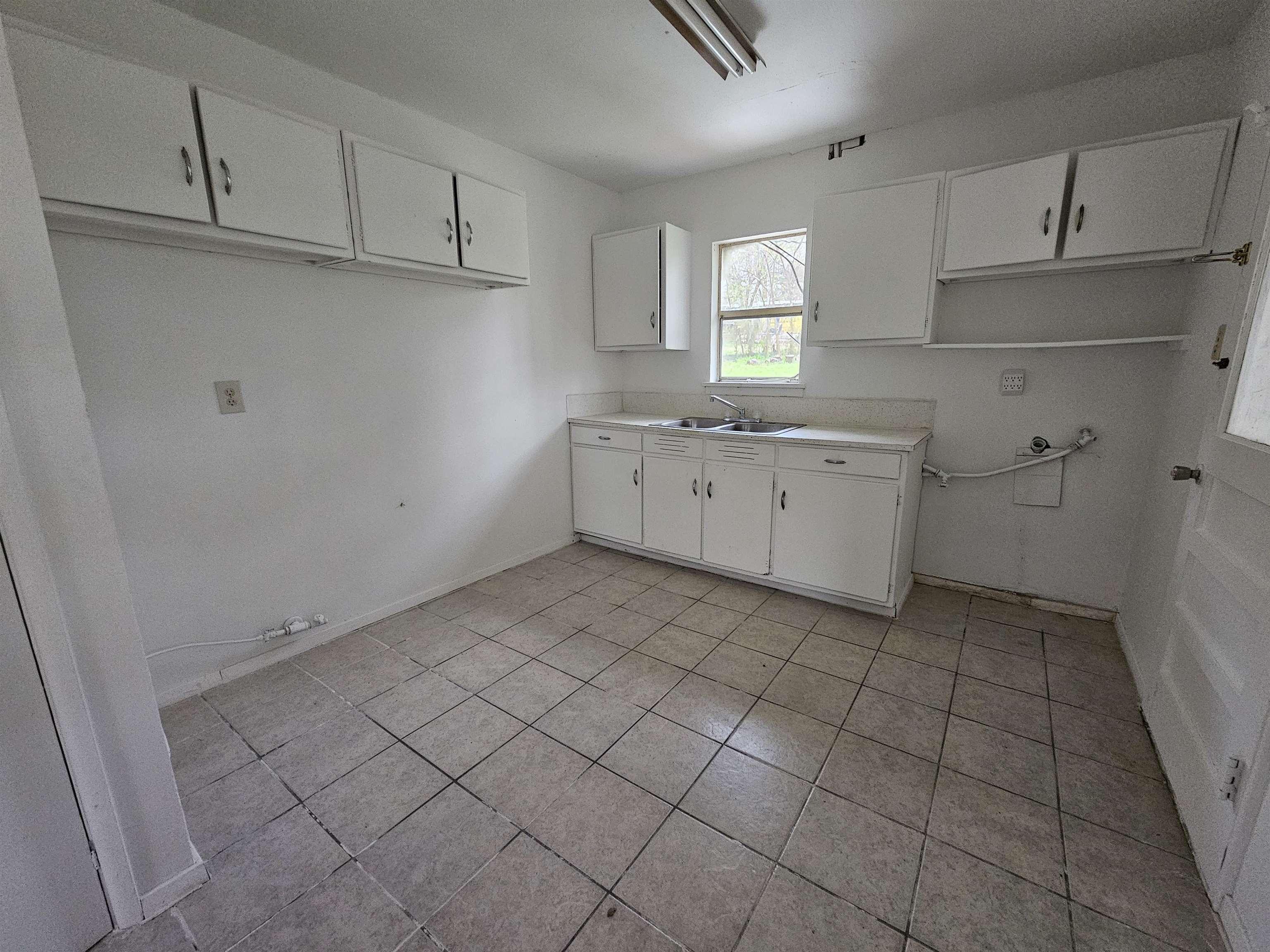 Image 3: Washroom with washer hookup, cabinet space, light tile patterned flooring, and gas dryer hookup, Laundry