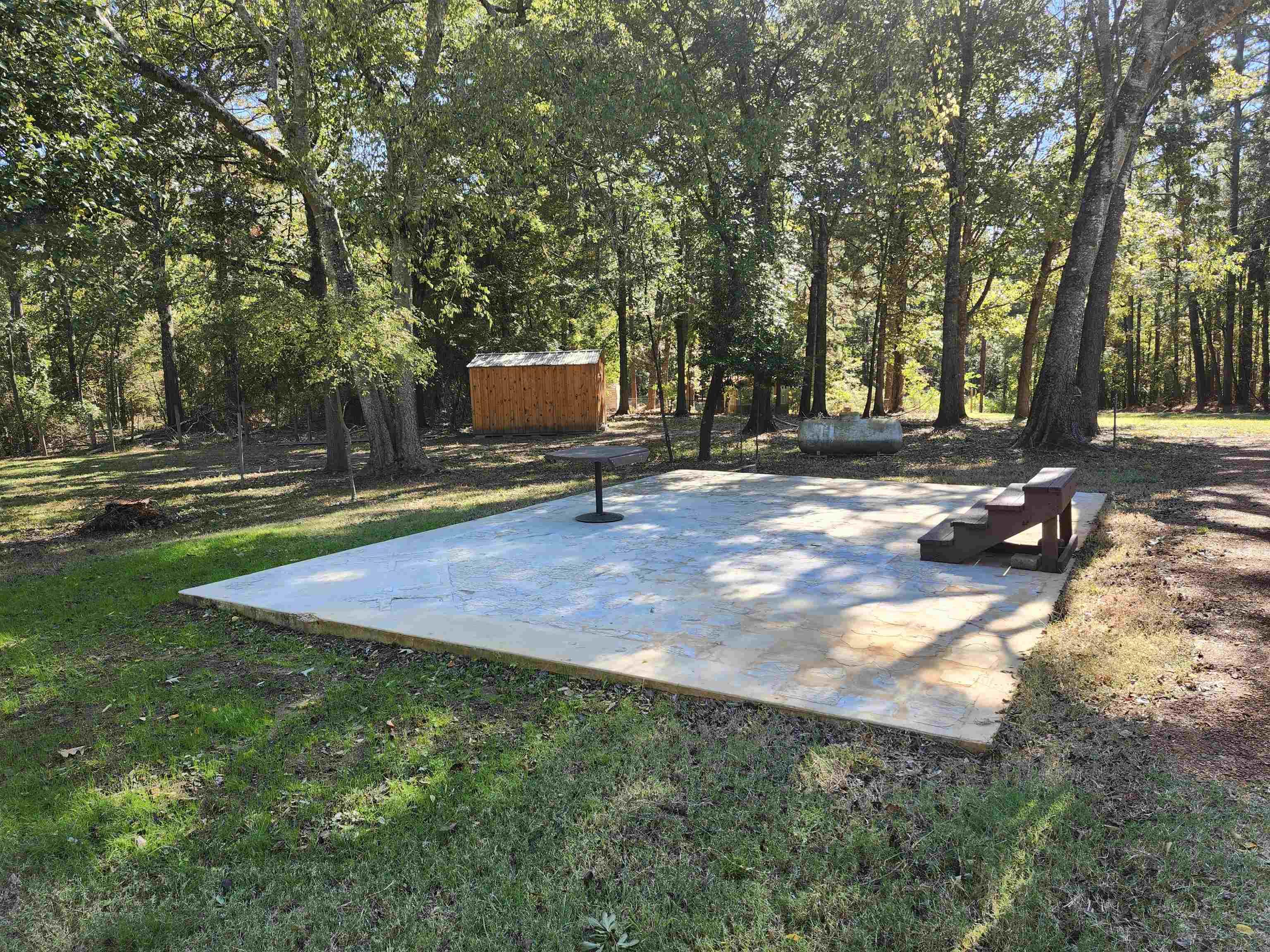 Image 0: View of patio featuring a storage unit, Patio