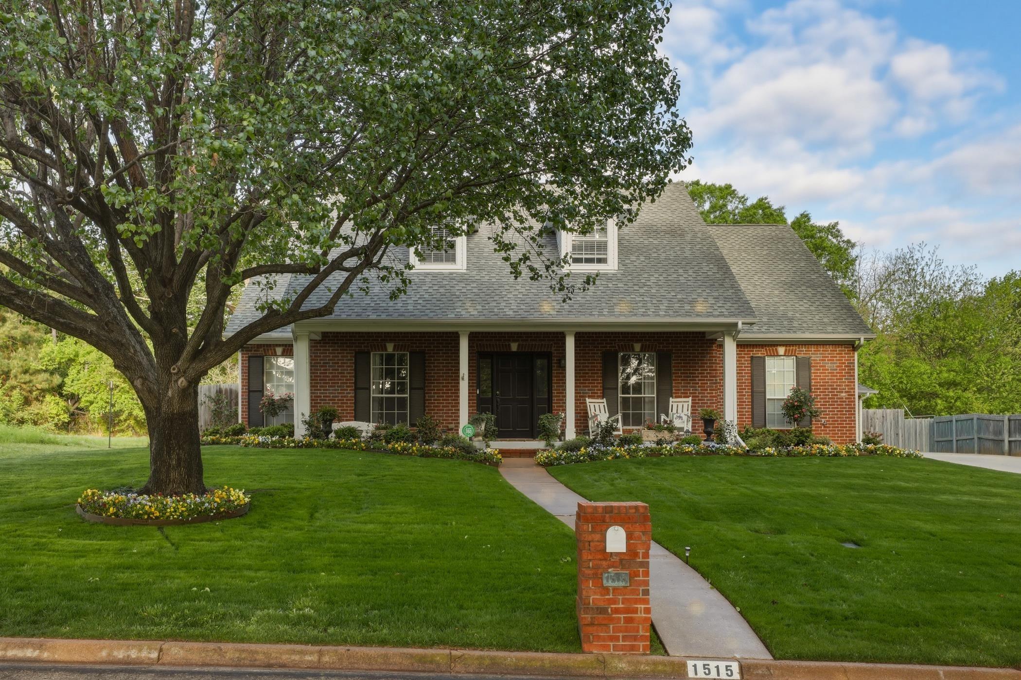 Image 0: Cape cod home featuring brick siding, covered porch, and a shingled roof, Front Of Structure