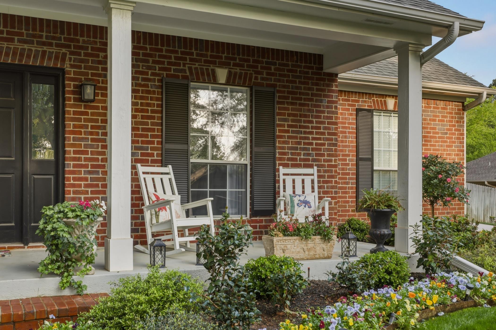 Image 3: Entrance to property with a porch, brick siding, and a shingled roof, Entry