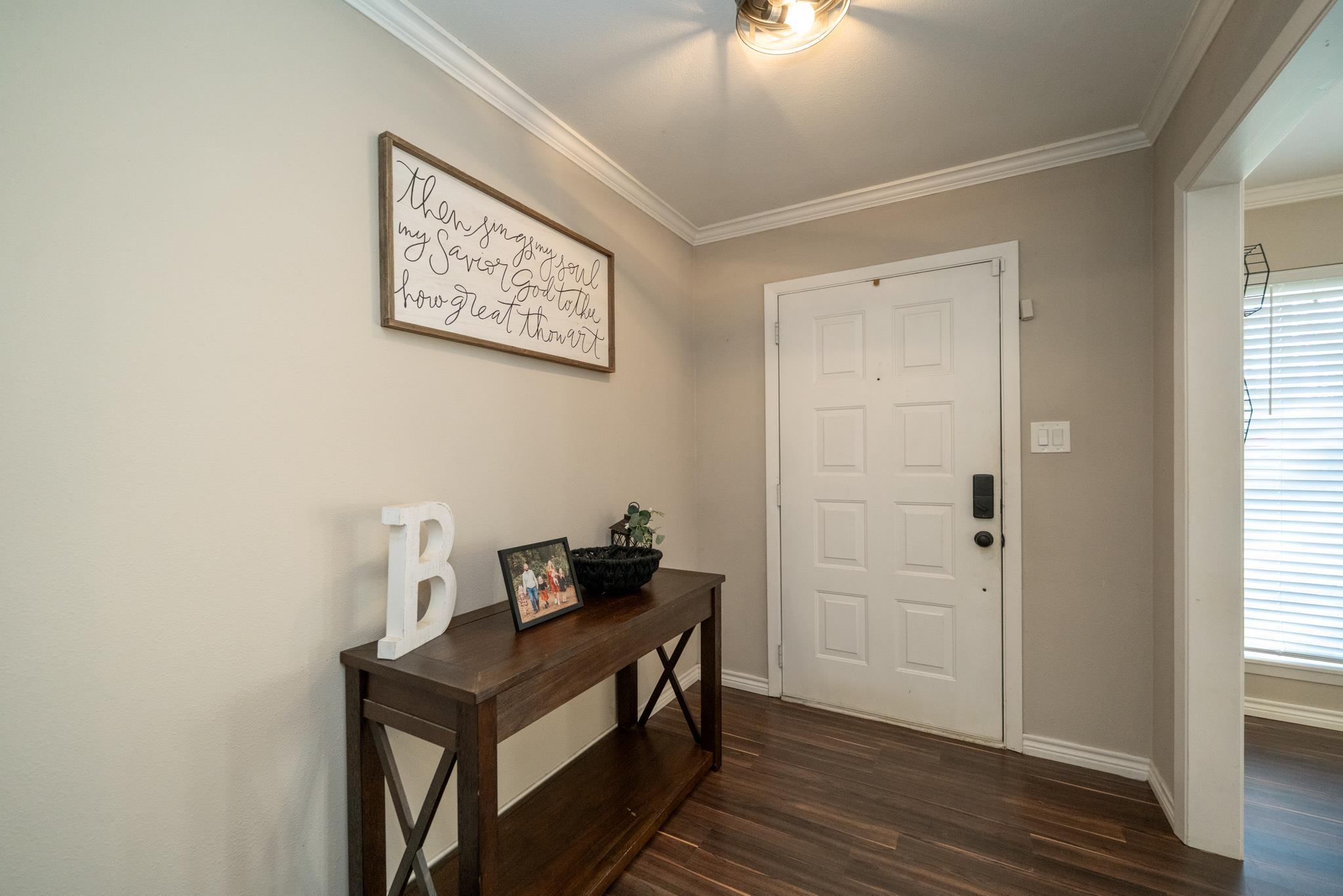 Image 2: Foyer entrance featuring ornamental molding and dark wood-style floors, Entrance Foyer