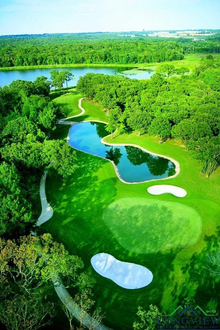 Image 3: Bird's eye view of a large body of water and a local golf course, Golf Course