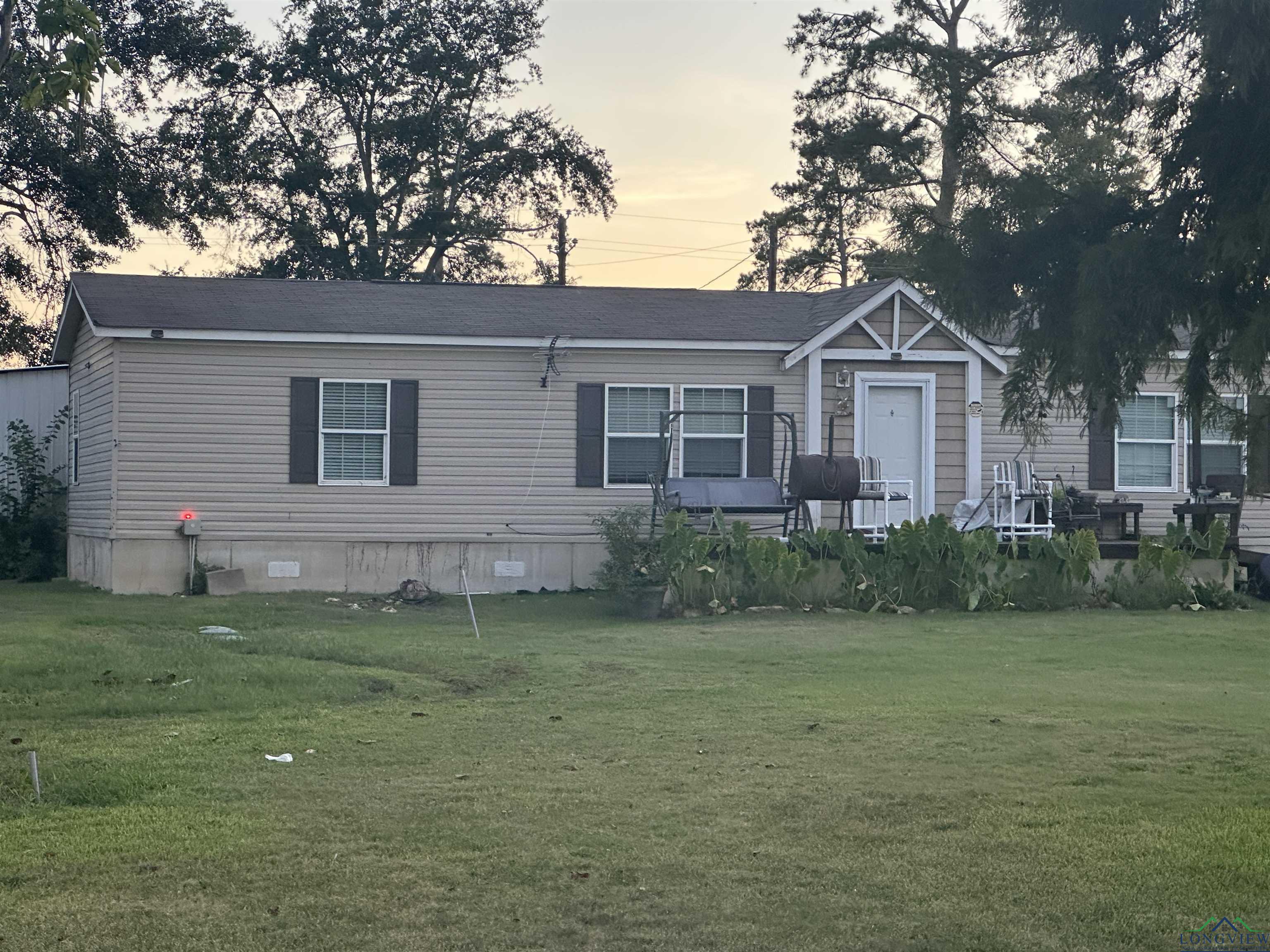Image 2: View of front of home featuring crawl space and a front lawn, Front Of Structure