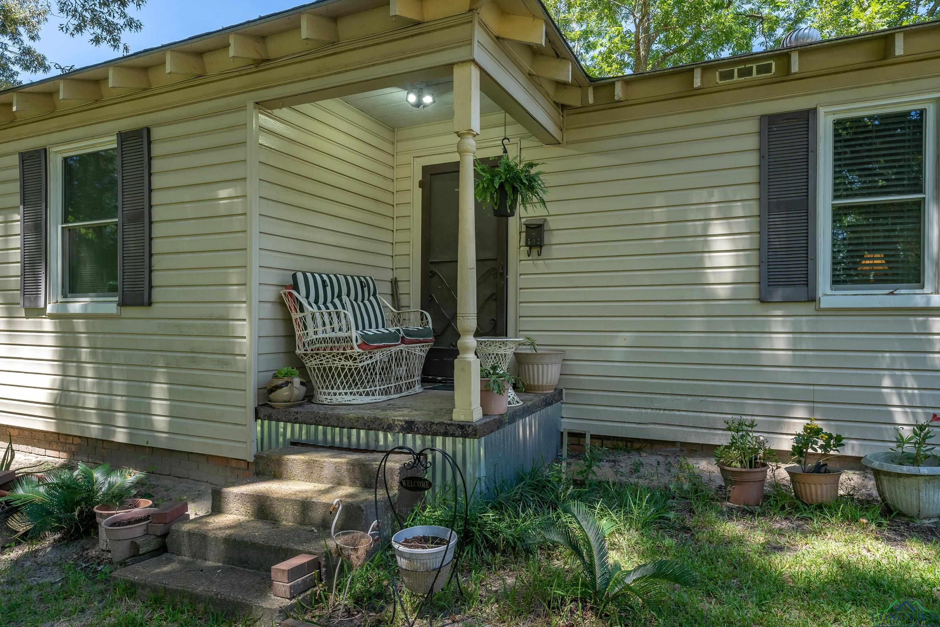 Image 2: View of side of property featuring covered porch, Side Of Structure