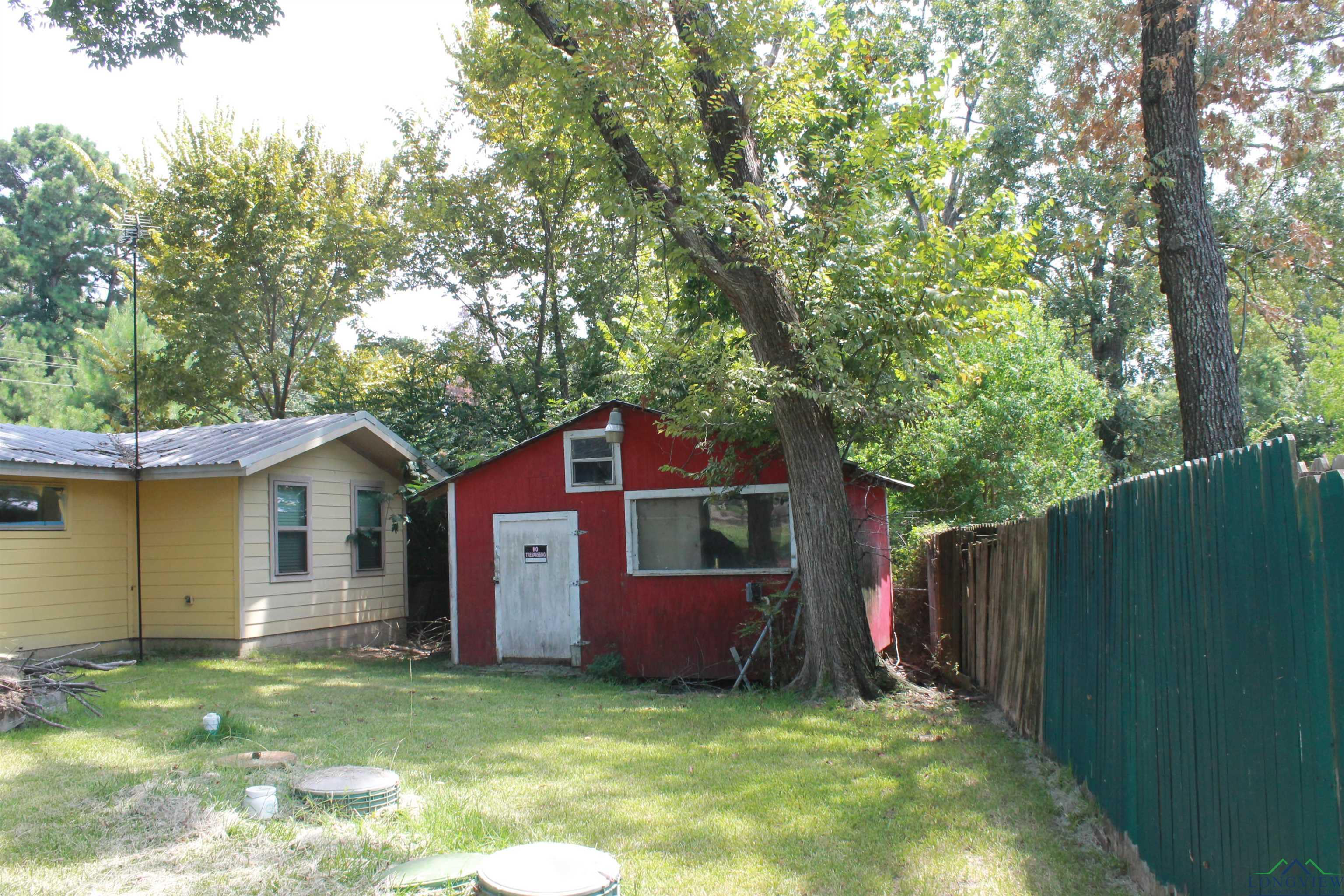 Image 2: View of yard with an outbuilding, Yard