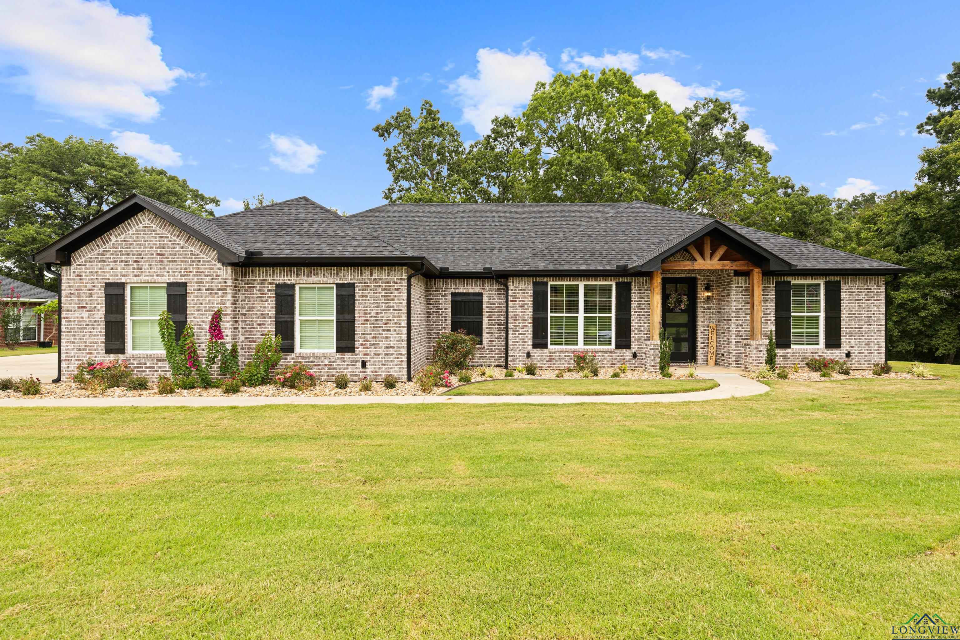 Image 0: View of front facade with brick siding, a shingled roof, and a front yard, Front Of Structure