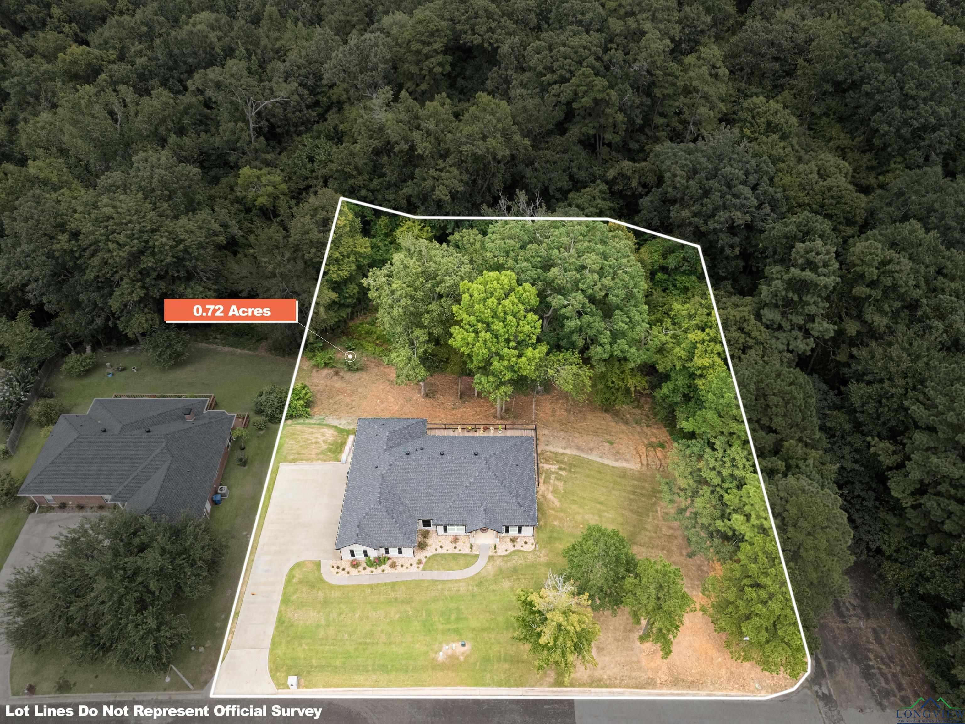 Image 1: View from above of property with property boundaries highlighted and a forest, Aerial View