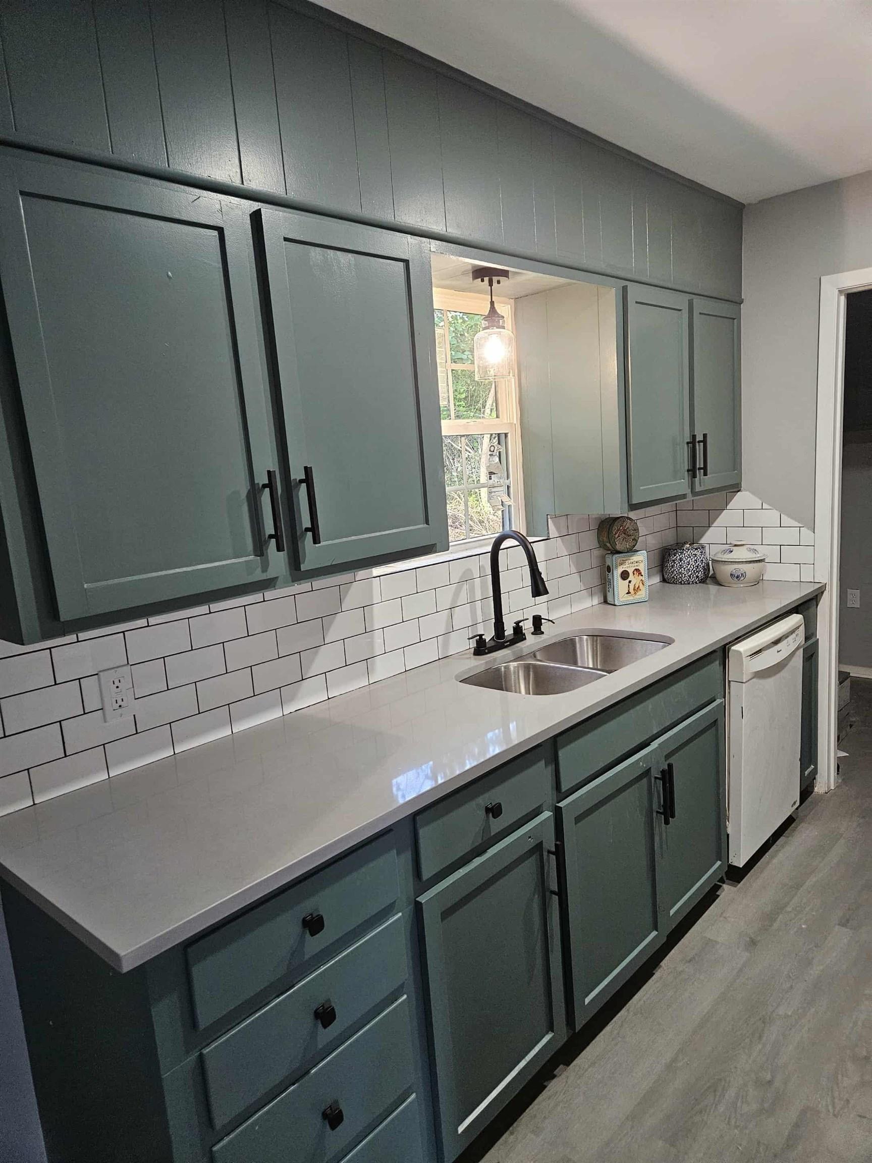 Image 0: Kitchen featuring decorative backsplash, light wood-style flooring, light stone counters, and dishwasher, Kitchen