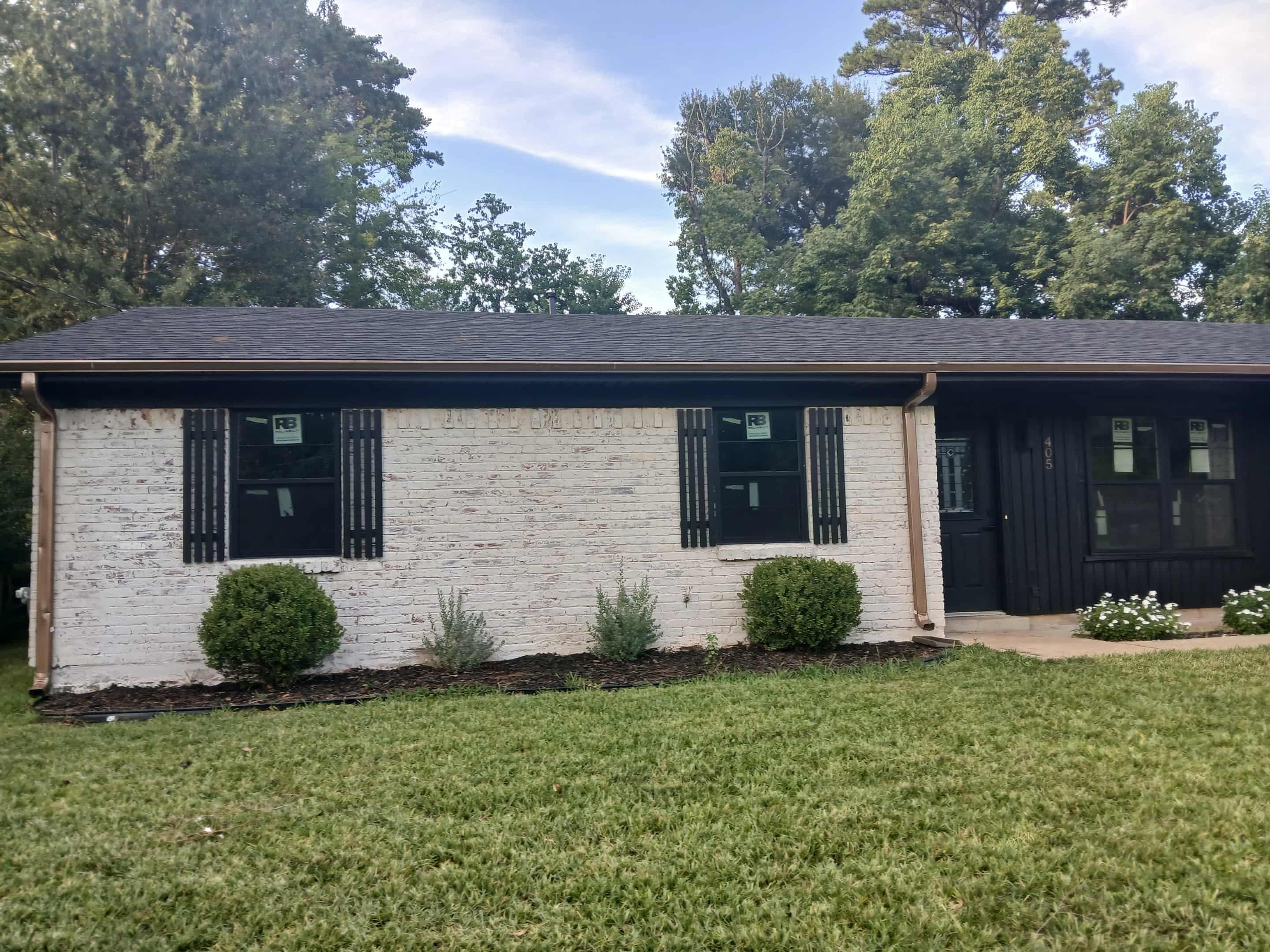 Image 1: Single story home featuring a front yard, brick siding, and covered porch, Front Of Structure