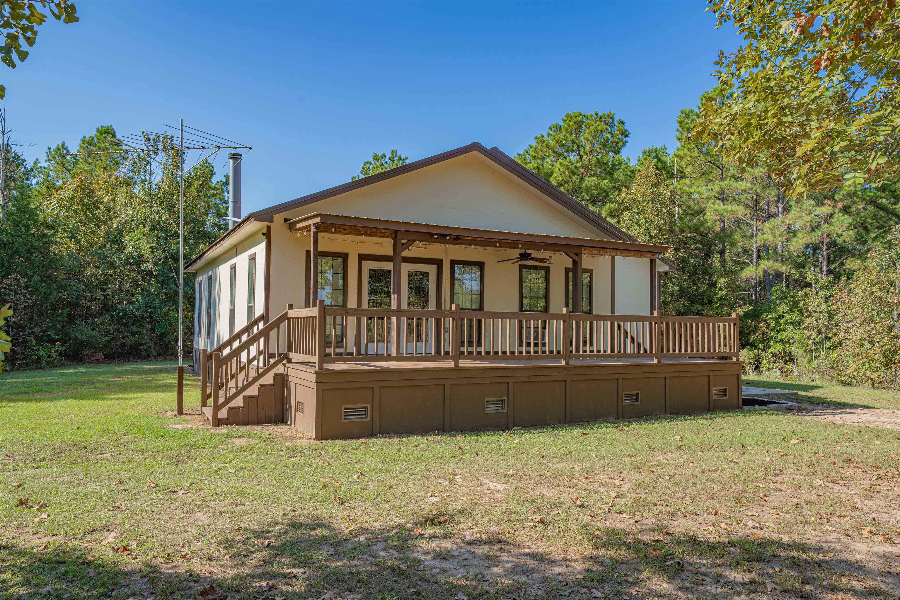 Image 3: Back of property featuring crawl space, ceiling fan, a yard, and a porch, Back Of Structure