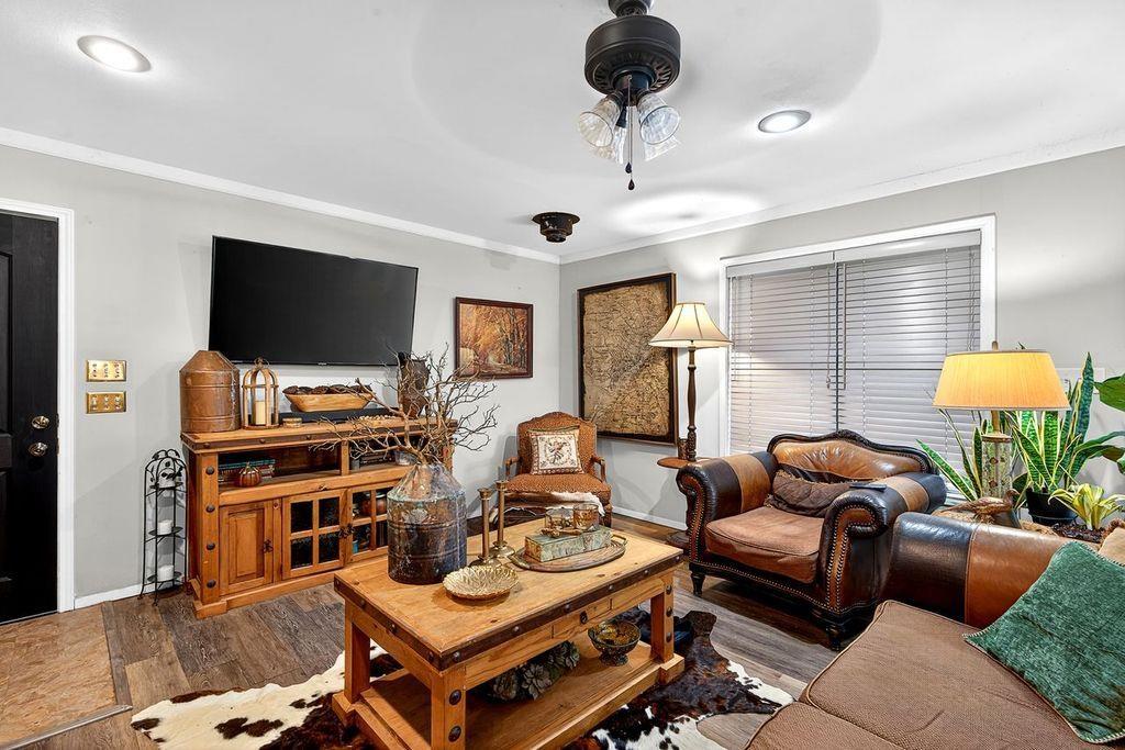 Image 1: Living room featuring wood finished floors, crown molding, and a ceiling fan, Main Living Room
