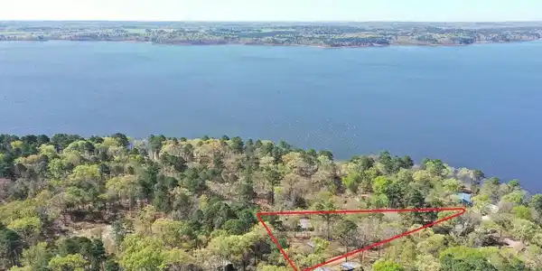 Image 1: Aerial overview of property's location featuring property parcel outlined and a large body of water, Aerial View