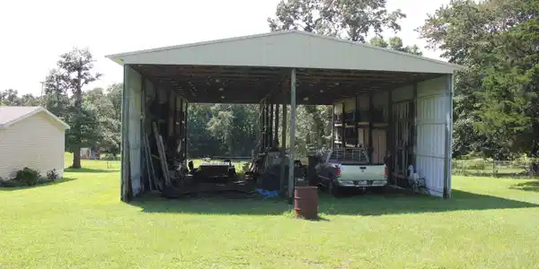 Image 3: Freestanding metal shed structure with a gabled roof and open bays, Out Buildings