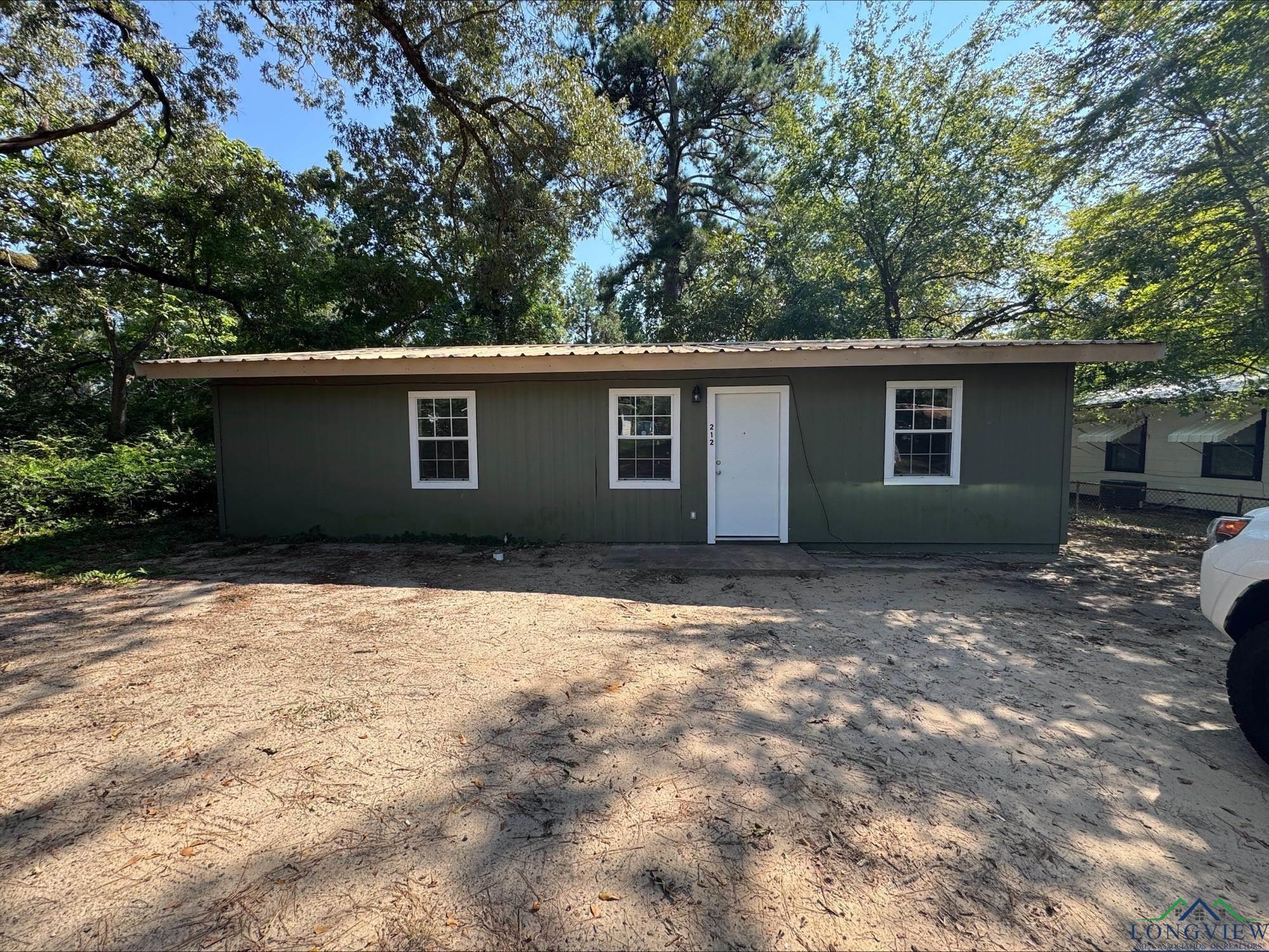 Image 0: Single story home featuring a metal roof, Front Of Structure