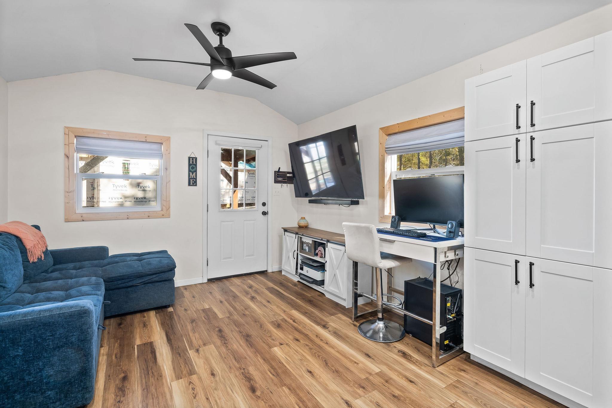 Image 3: Office area with lofted ceiling, light wood-style flooring, and ceiling fan, Office