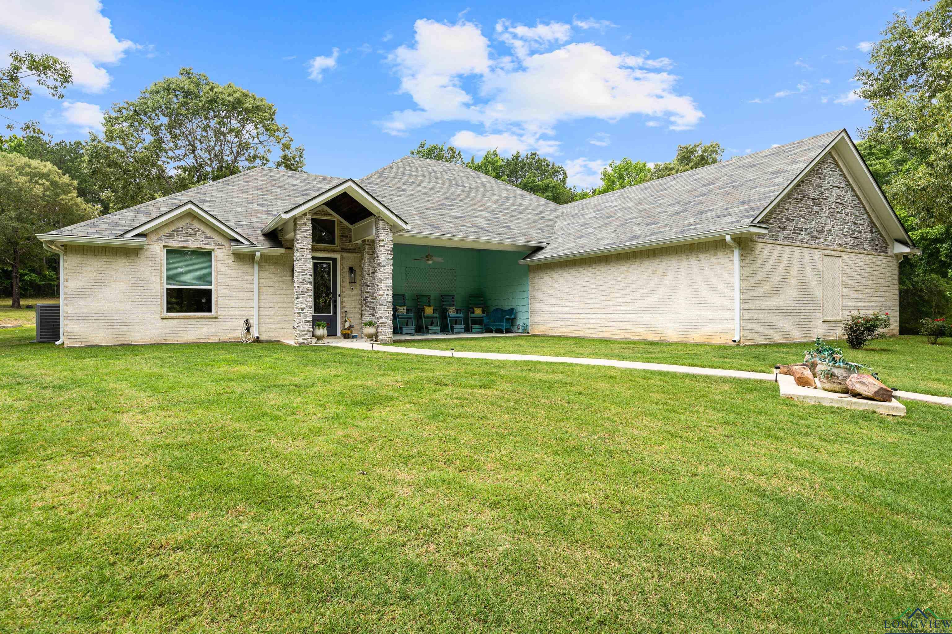 Image 0: View of front facade with a front yard, brick siding, and a shingled roof, Front Of Structure
