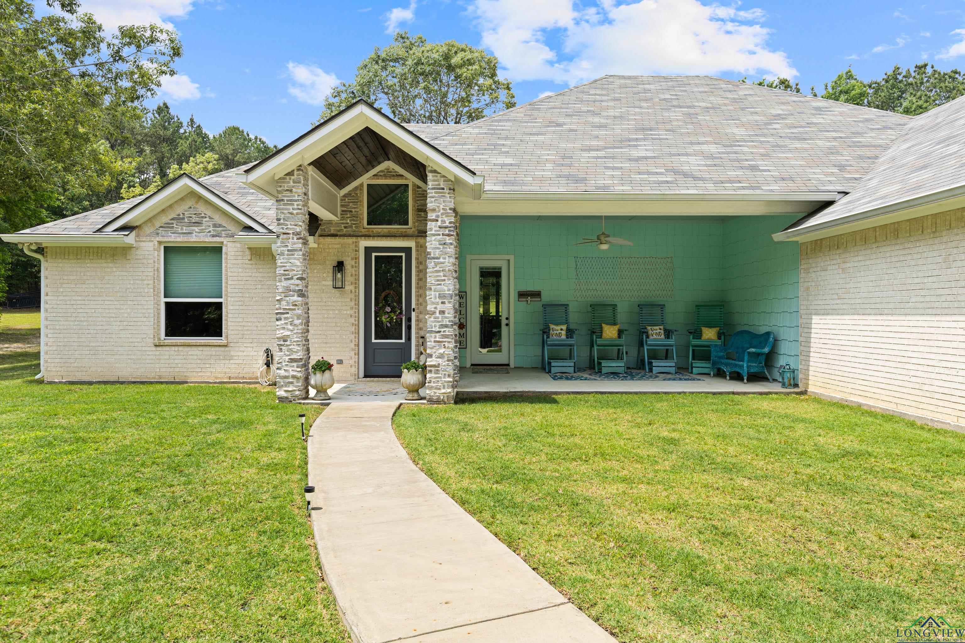 Image 1: View of front of home with a ceiling fan, a front yard, a patio area, and roof with shingles, Front Of Structure