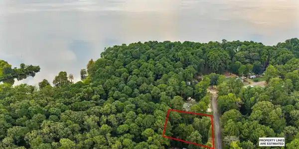 Image 2: Aerial view of property and surrounding area featuring property parcel outlined and a nearby body of water, Aerial View