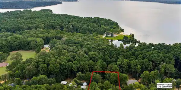 Image 3: Aerial overview of property's location featuring property parcel outlined and a large body of water, Aerial View