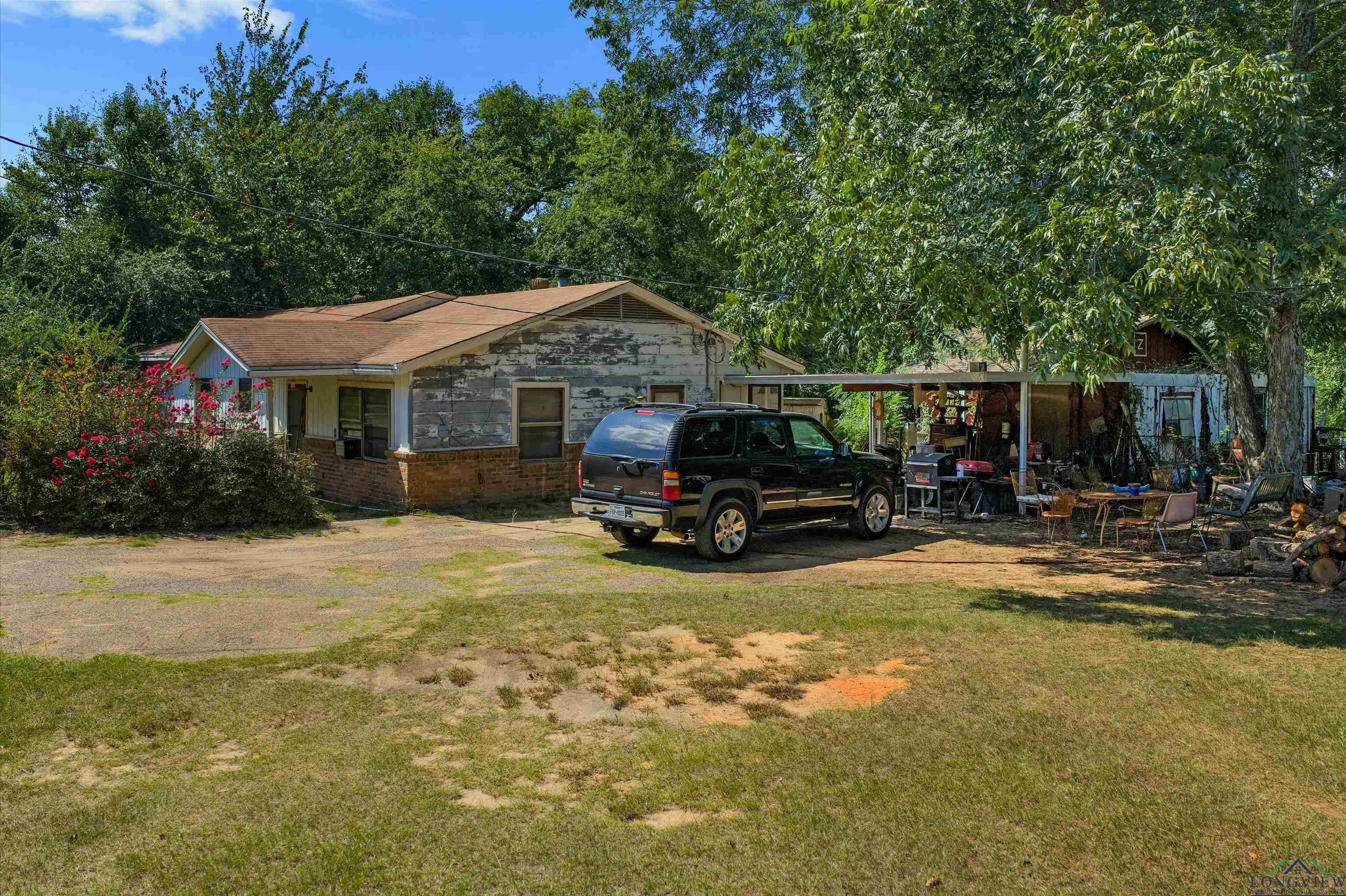 Image 1: View of front of house with a front lawn and brick siding, Front Of Structure