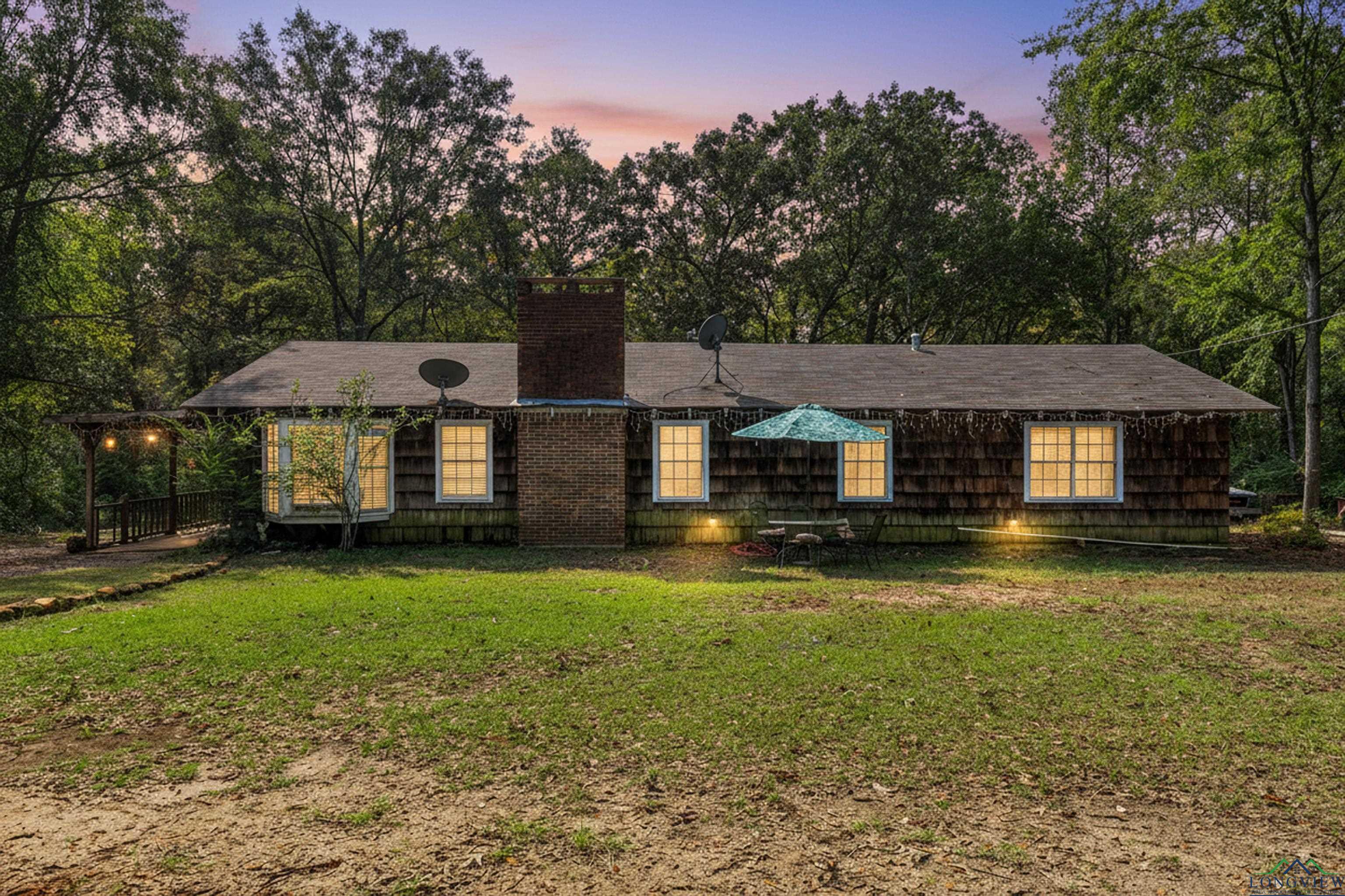 Image 0: Ranch-style home featuring a yard and a chimney, Front Of Structure