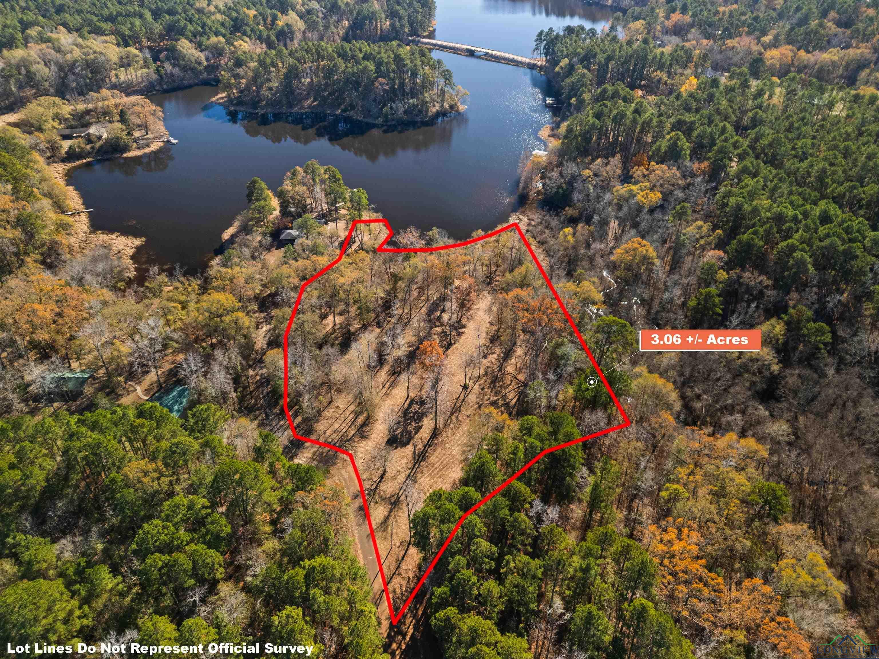 Image 0: View of property location with a nearby body of water and property parcel outlined, Aerial View